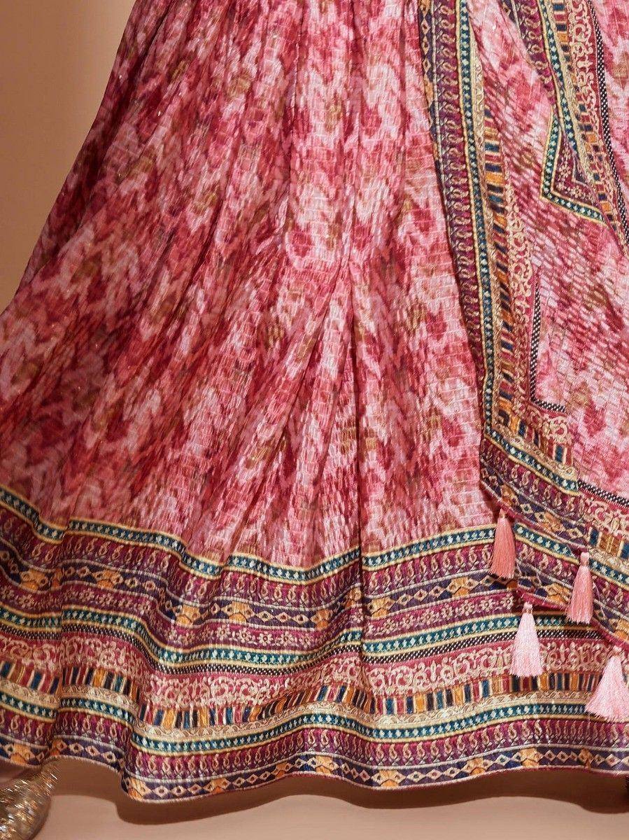 Pink printed lehenga with intricate border and tassels, ethnic Indian wear