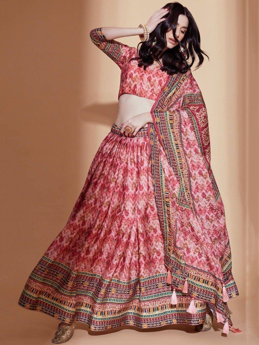 Pink printed lehenga choli with ethnic border and tassels, perfect for Indian festive occasions