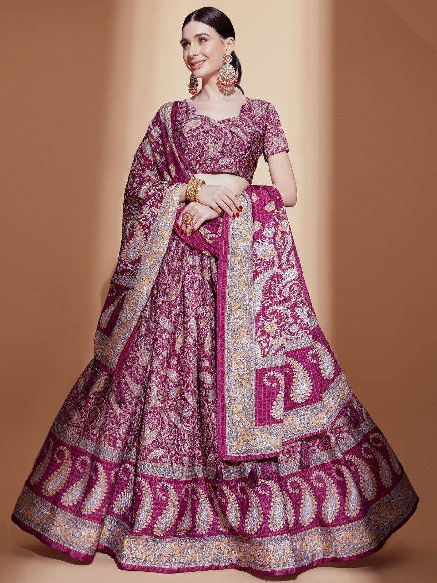 Elegant maroon lehenga choli with intricate paisley embroidery, perfect for Indian weddings and festive occasions.