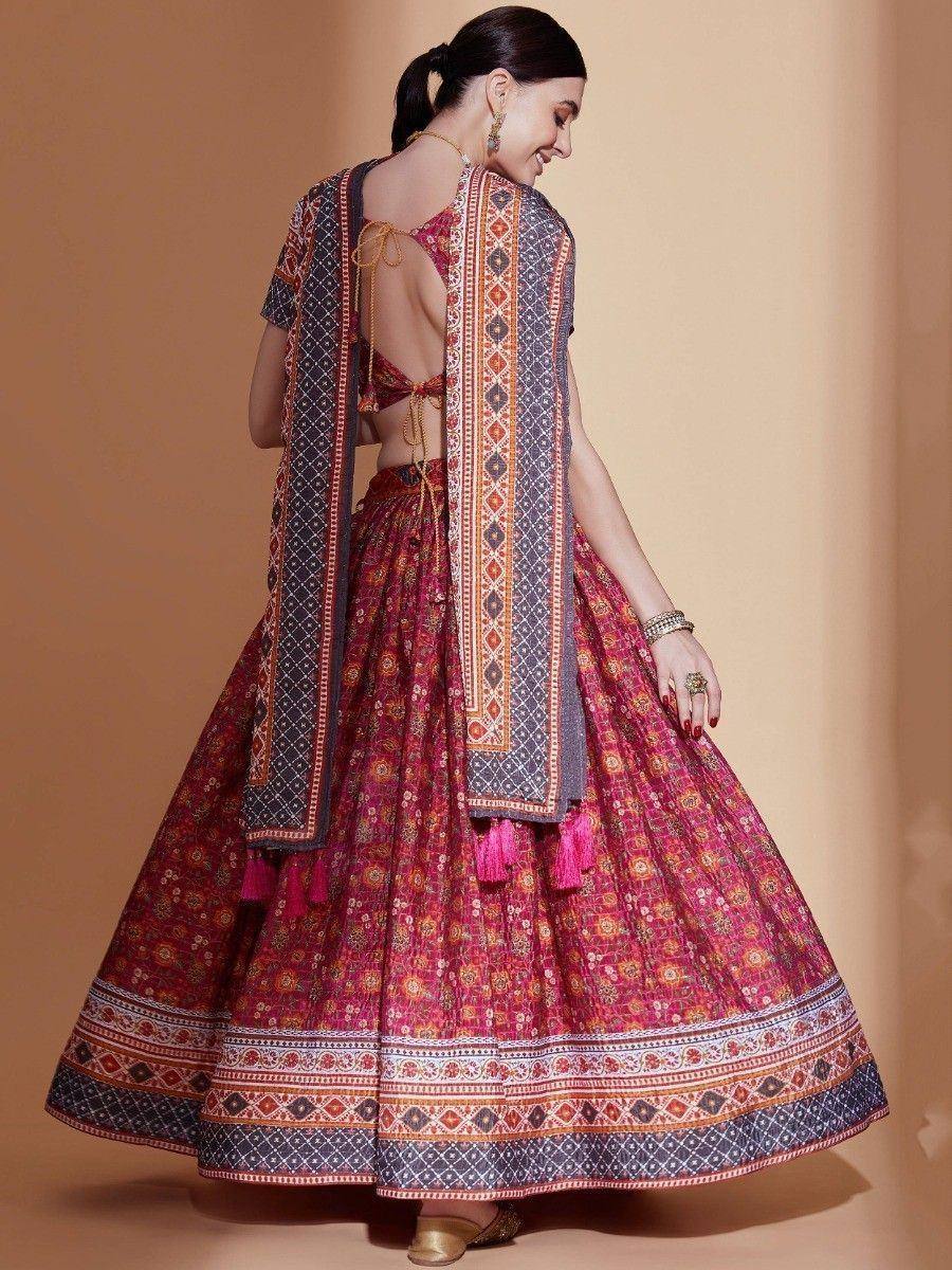 Woman in vibrant printed lehenga choli with backless blouse and matching dupatta, ethnic Indian wear