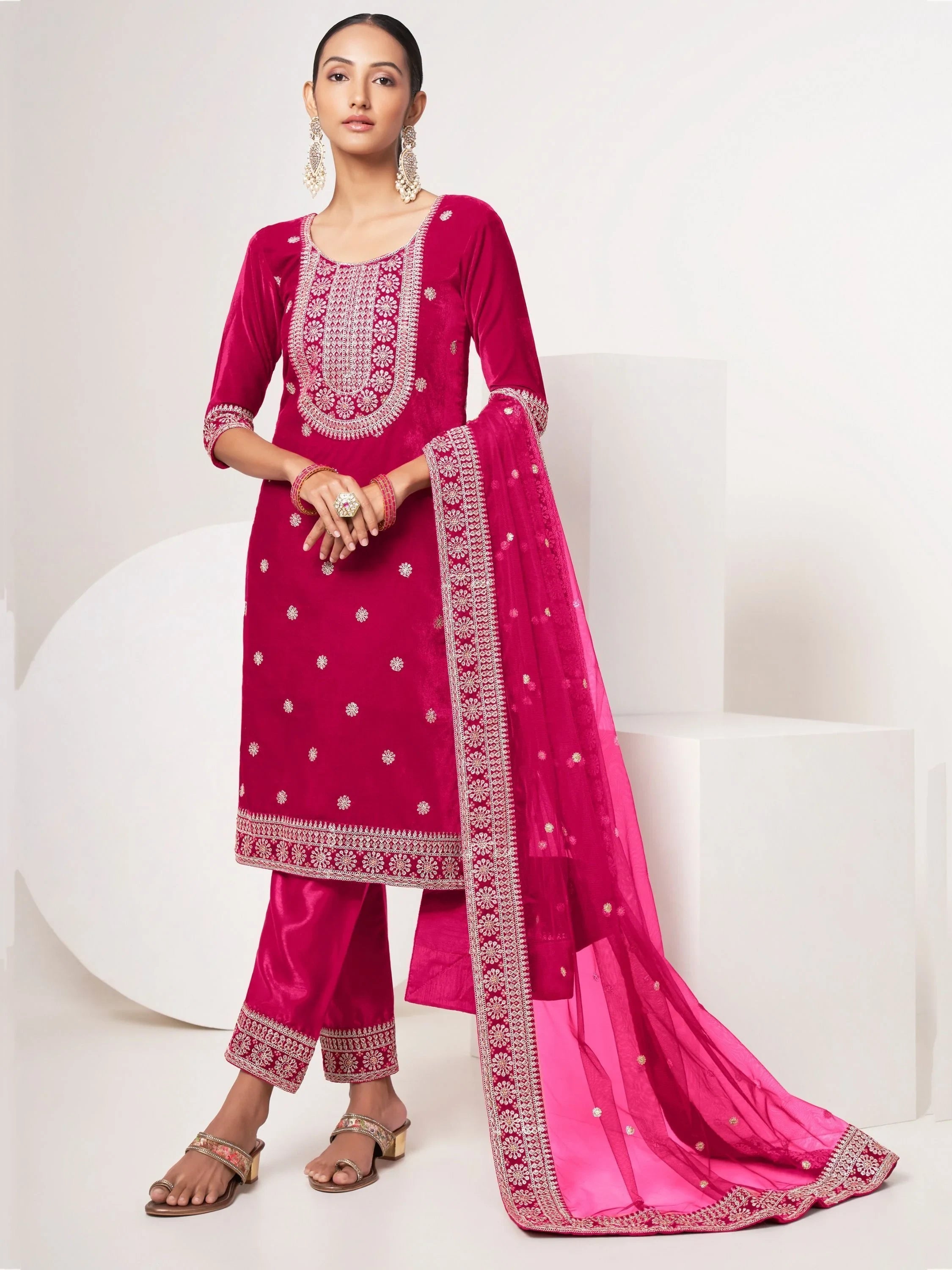 Woman wearing pink embroidered salwar kameez set with dupatta and statement earrings