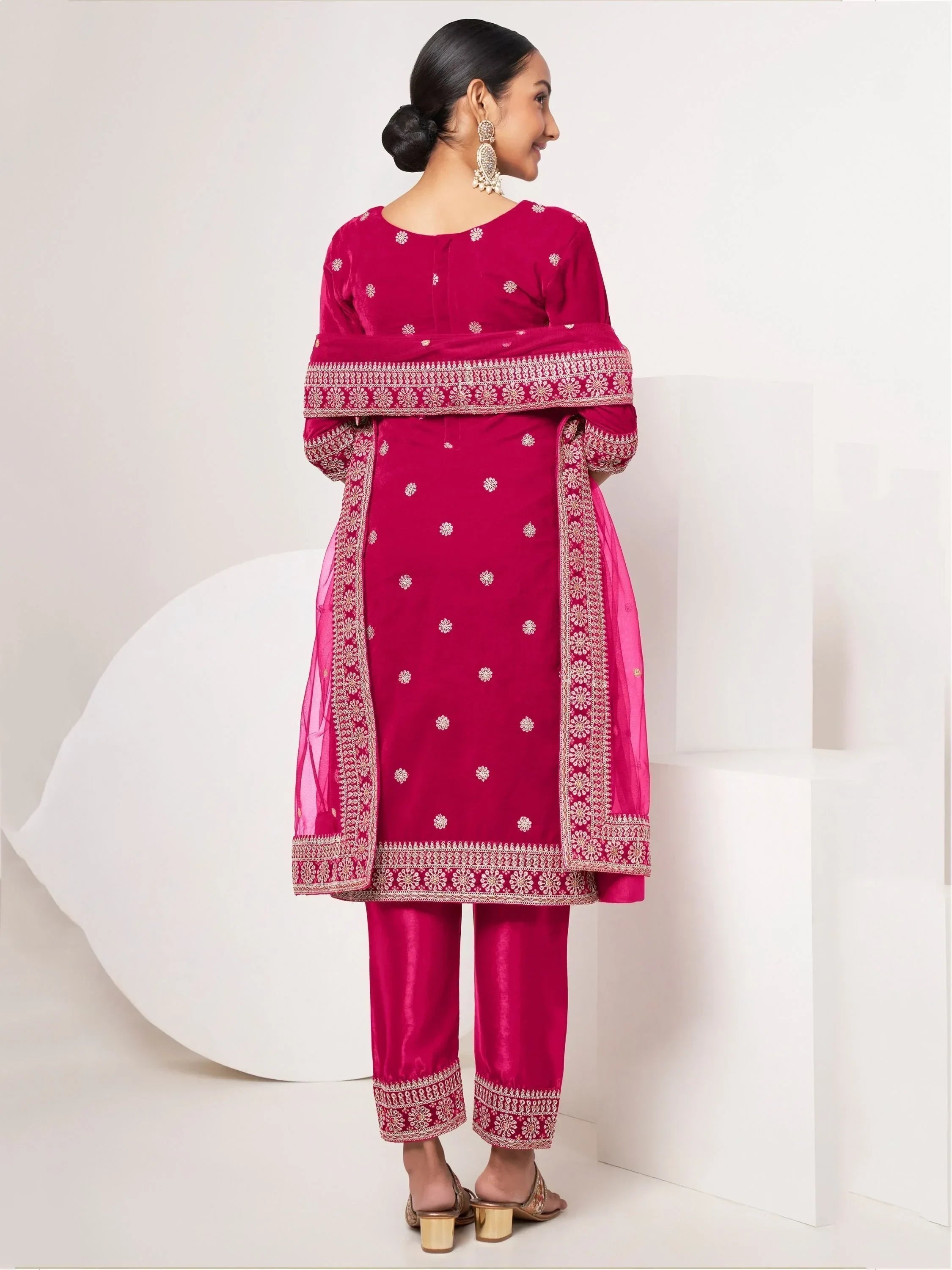 Woman wearing magenta embroidered salwar kameez with dupatta, back view, ethnic fashion