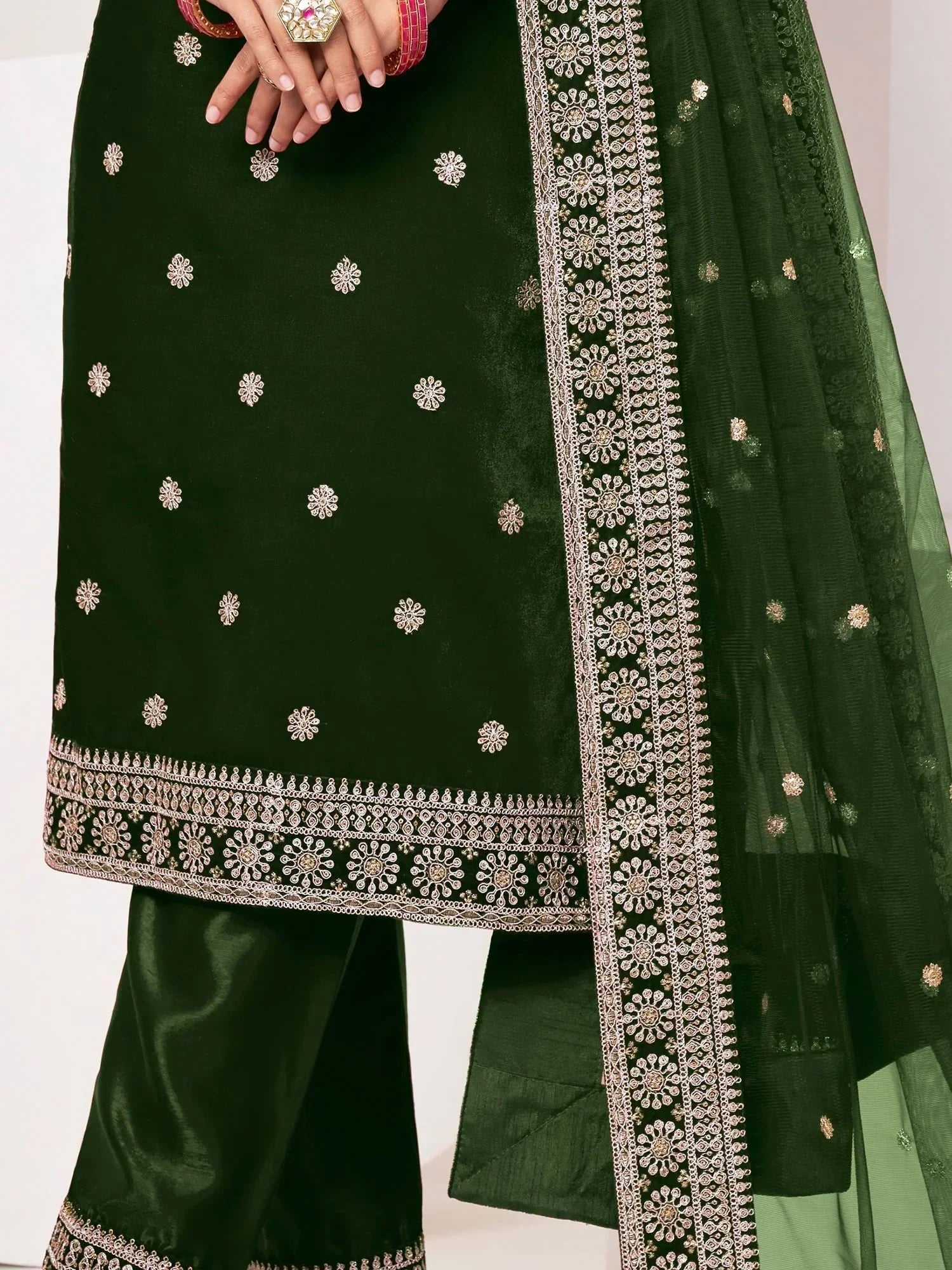 Dark green embroidered salwar kameez with matching dupatta and intricate gold detailing