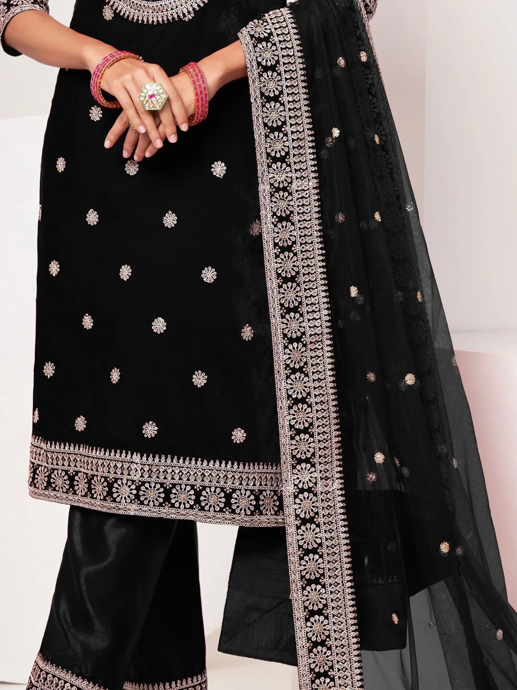 Black embroidered salwar kameez with matching dupatta and silver floral patterns