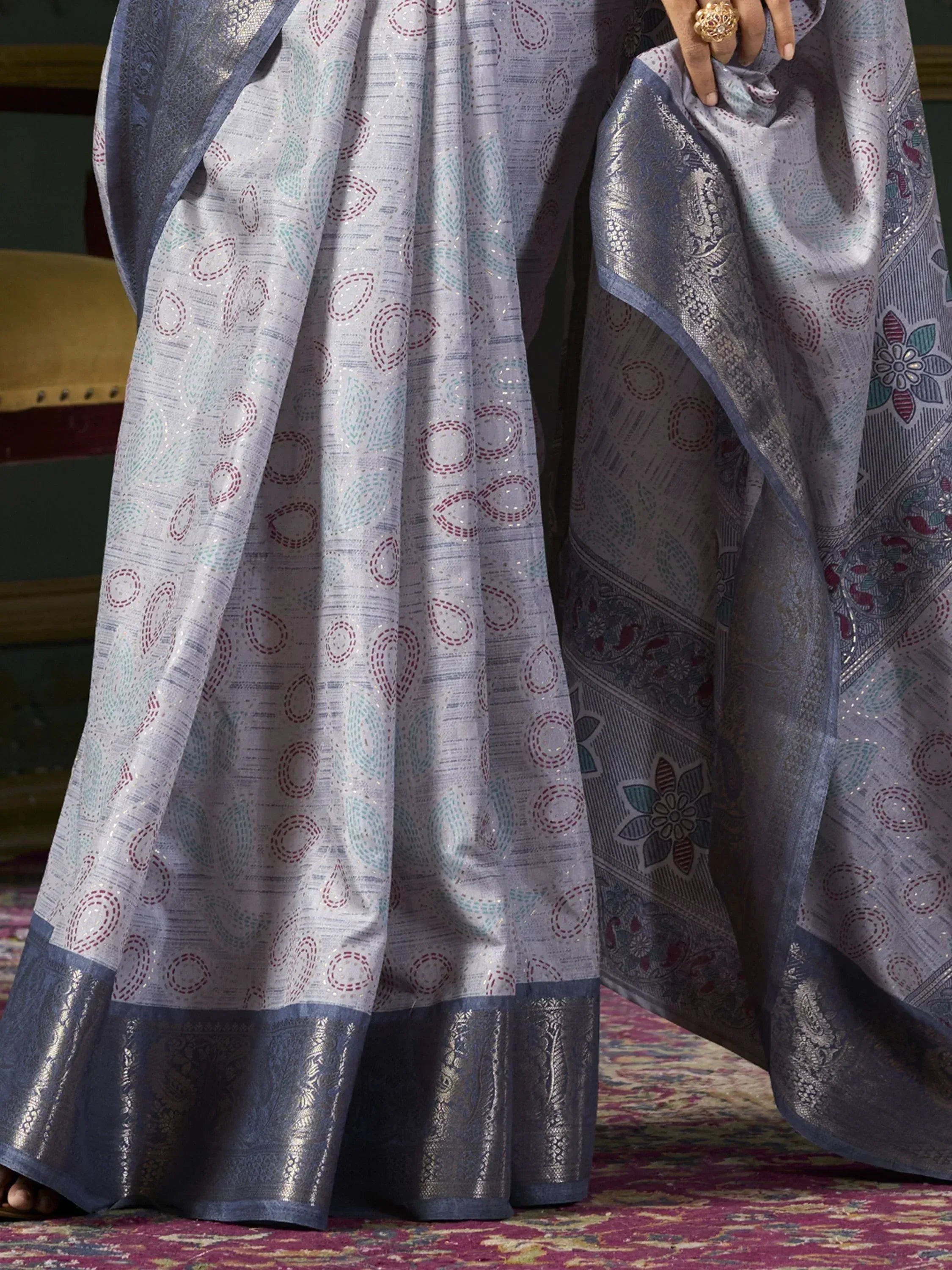 Elegant grey saree with intricate circular and floral motifs, perfect for Indian ethnic wear occasions.