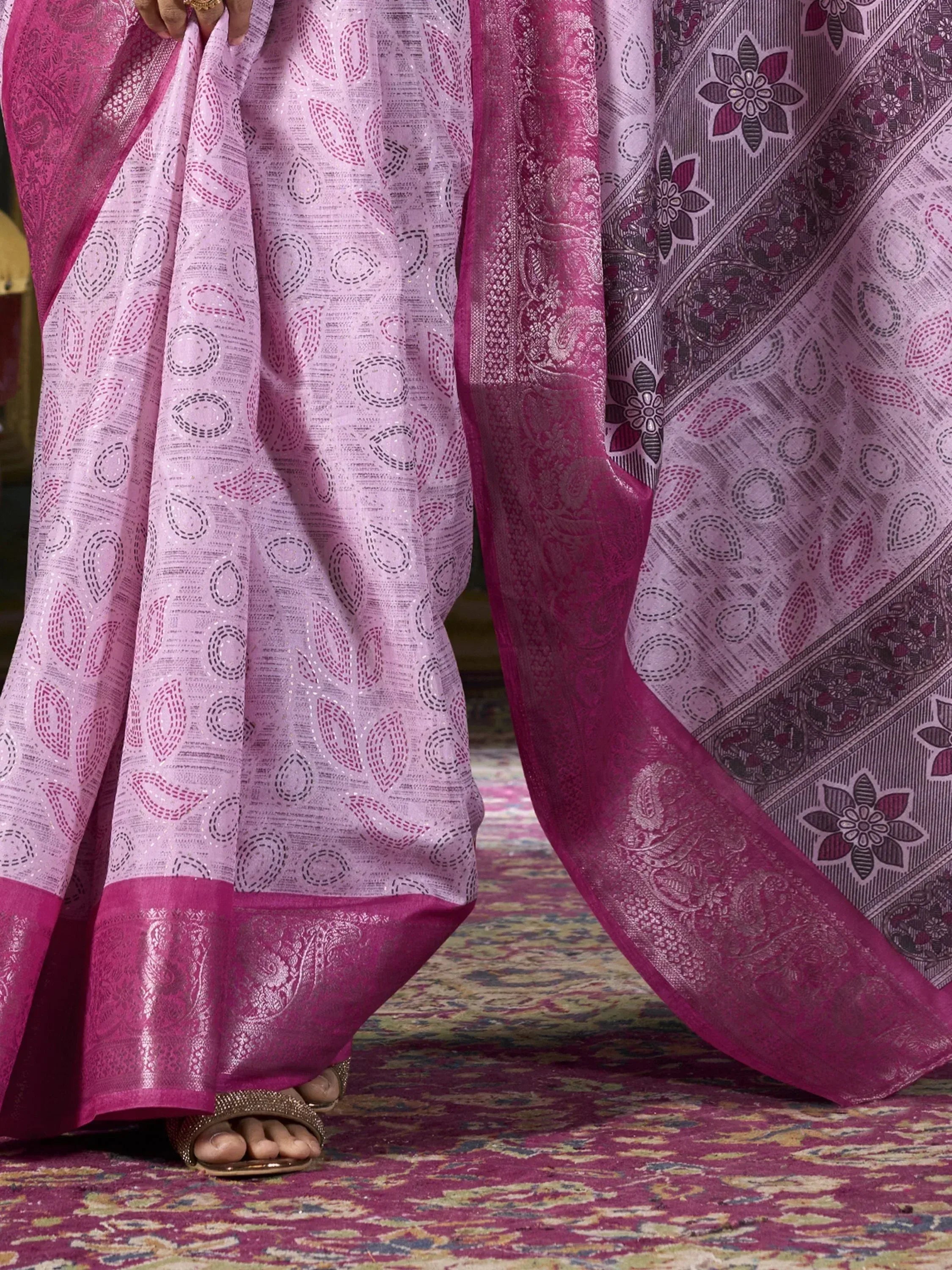 Pink ethnic saree with floral and paisley border, perfect for Indian occasions