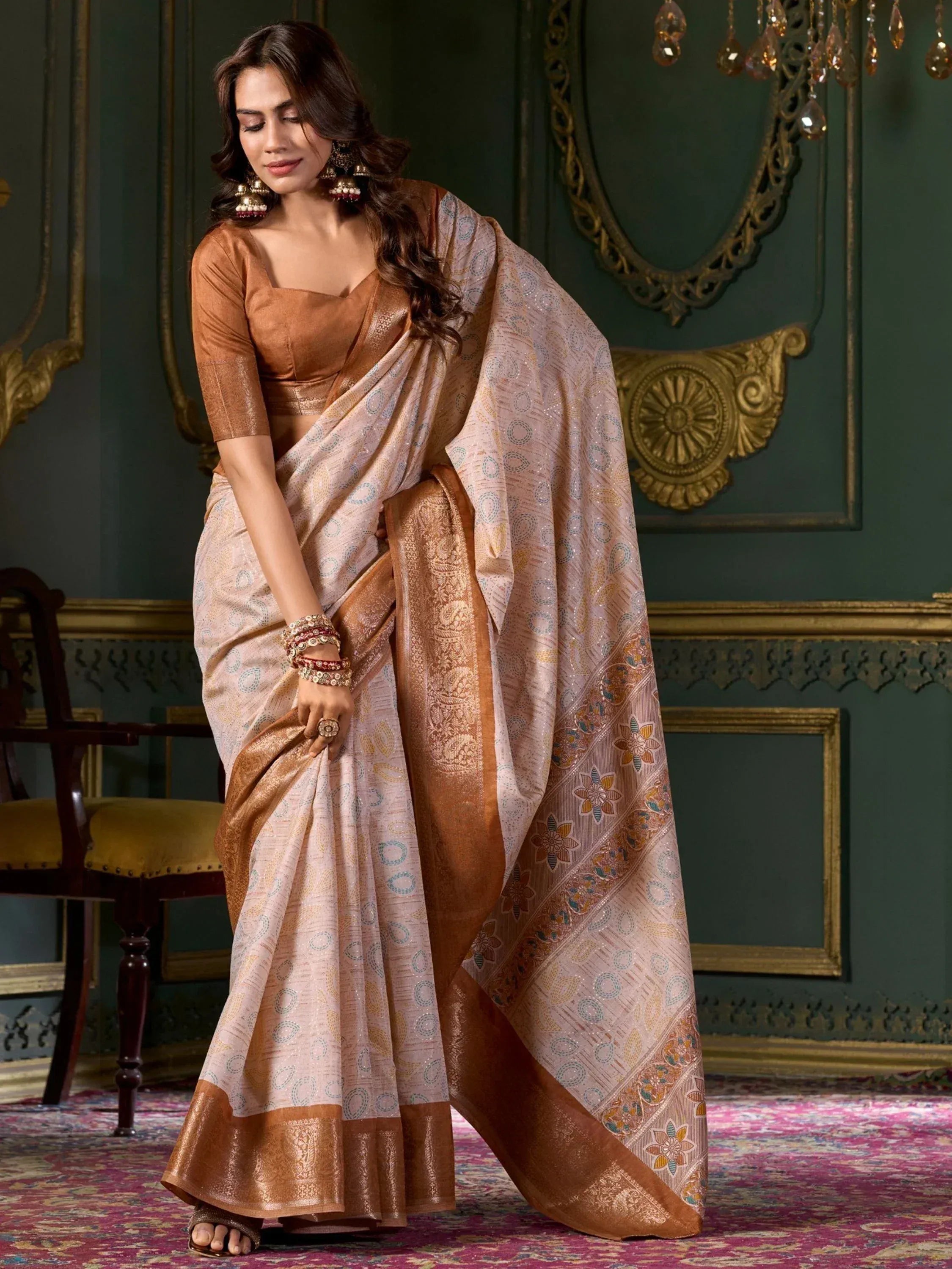 Elegant woman in designer saree with gold border and floral motifs, paired with matching blouse for Indian ethnic wear.