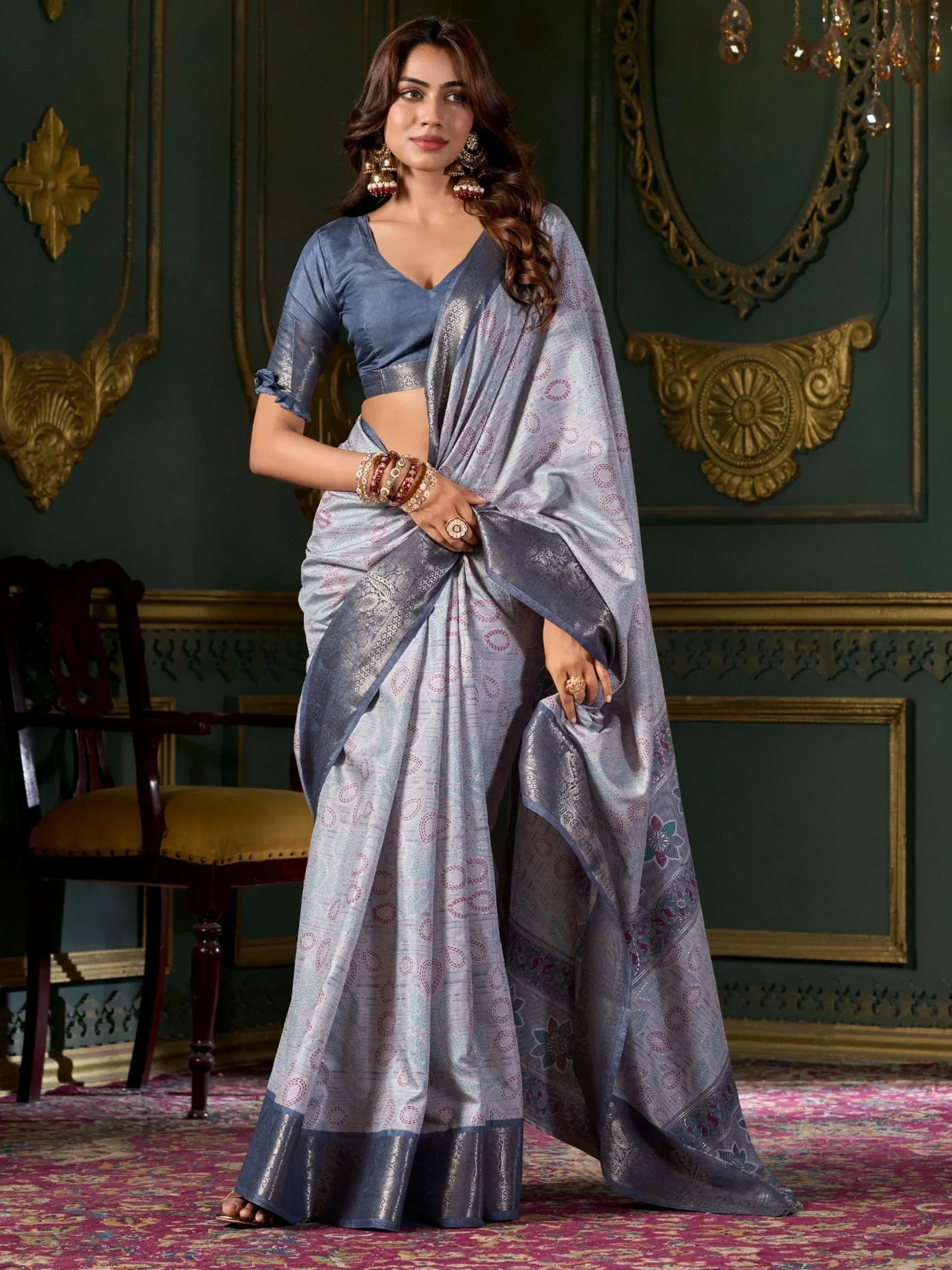 Elegant blue designer saree with intricate patterns and matching blouse, perfect for Indian ethnic occasions.