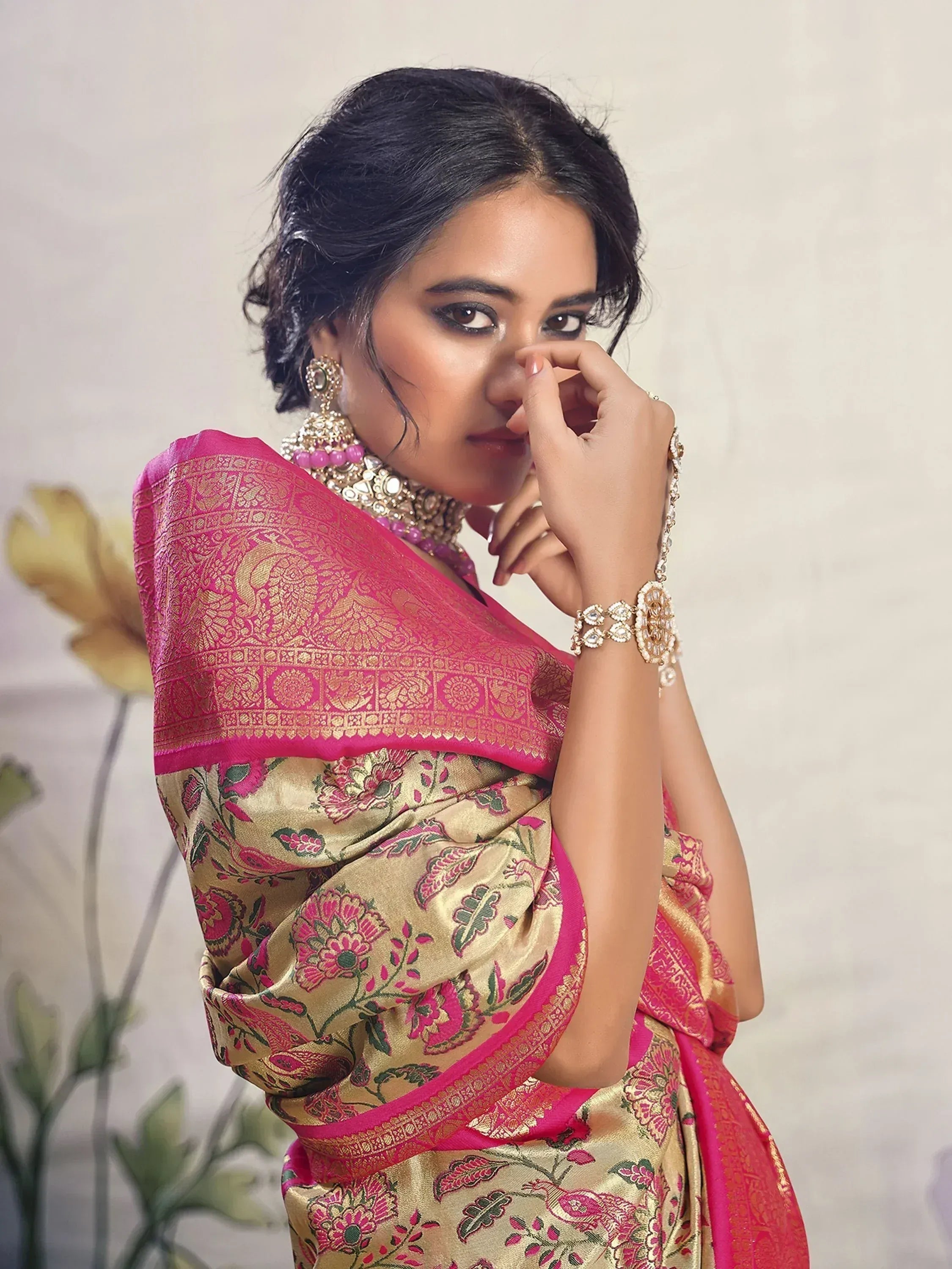 Woman in pink and gold floral saree with traditional jewelry, Indian ethnic wear