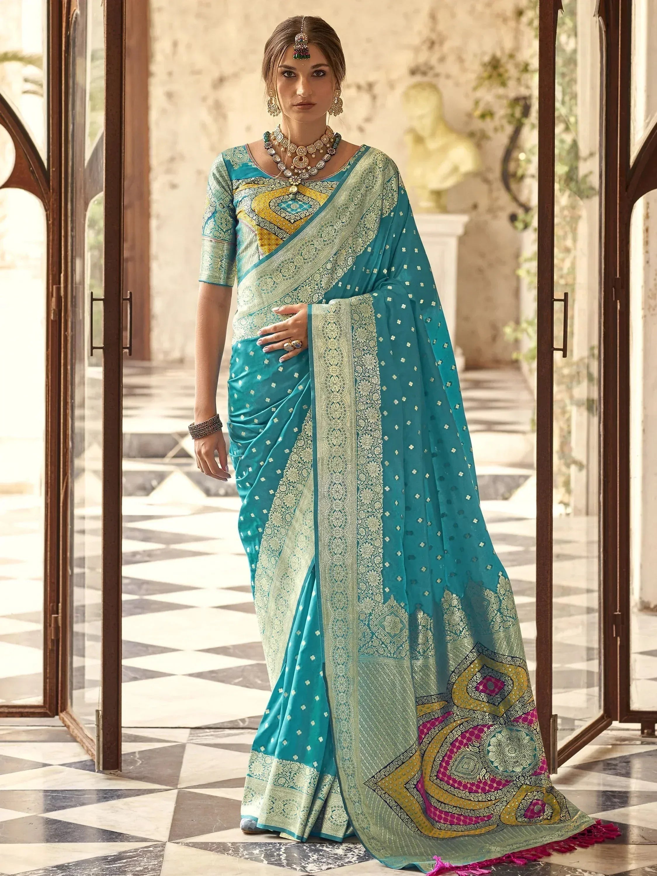 Teal designer saree with gold embroidery and colorful border, perfect for Indian ethnic wear occasions