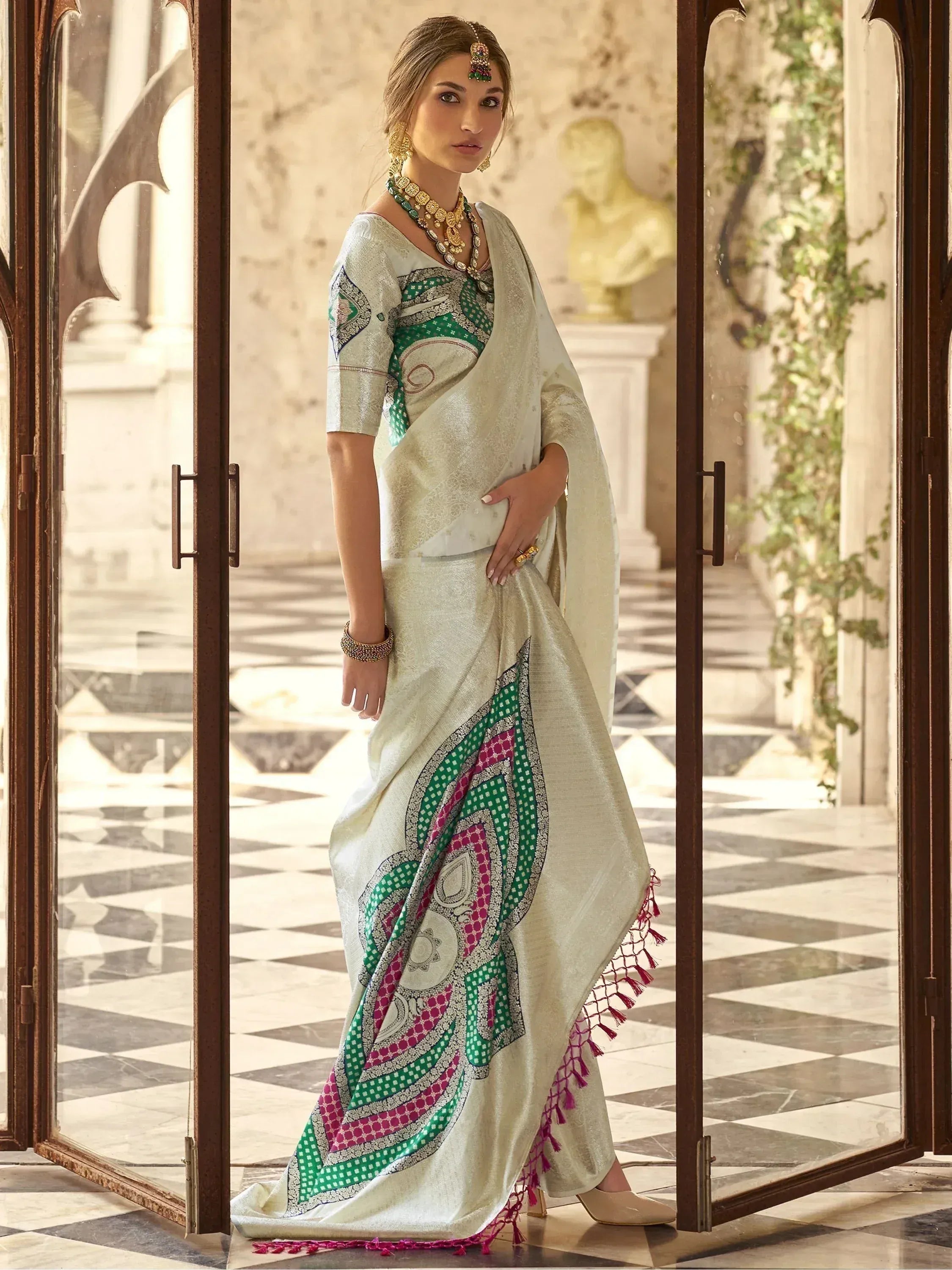 Elegant cream saree with green and pink geometric print, perfect for Indian ethnic occasions.