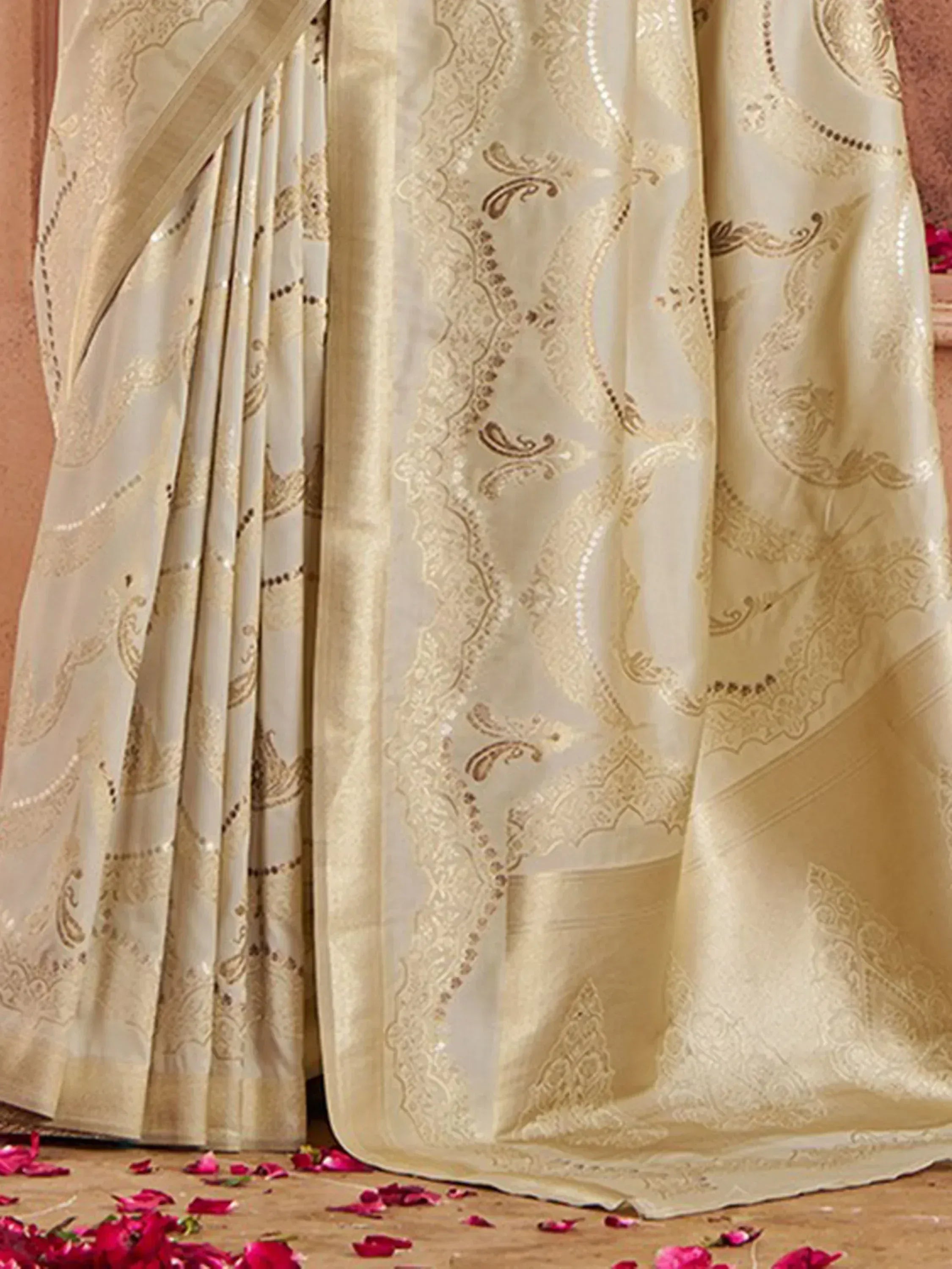 Cream designer saree with gold paisley embroidery and sequin detailing, perfect for Indian ethnic wear occasions.