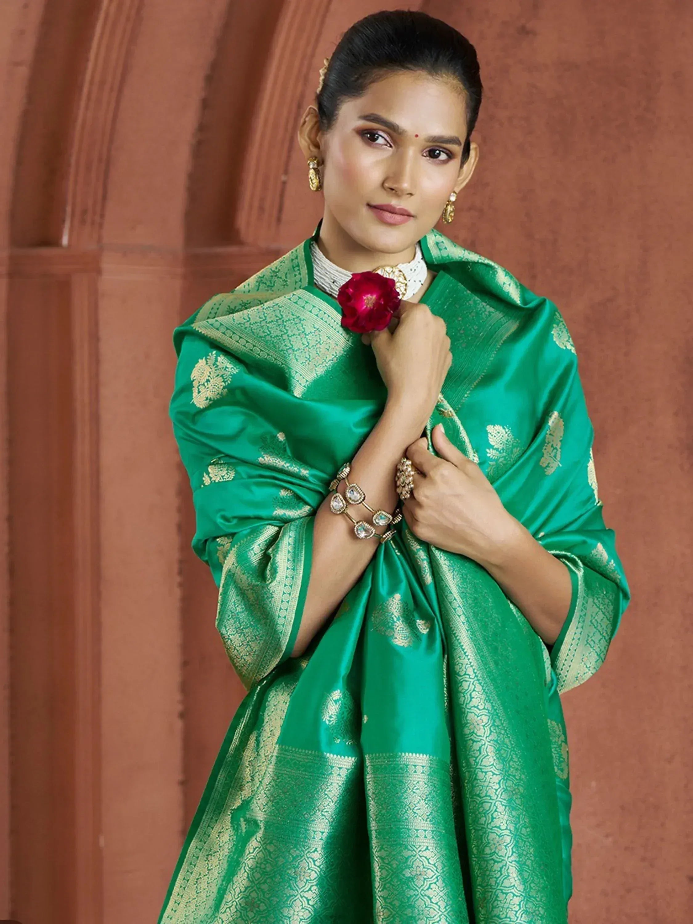 Emerald green silk saree with gold zari work, perfect for Indian ethnic wear and festive occasions.
