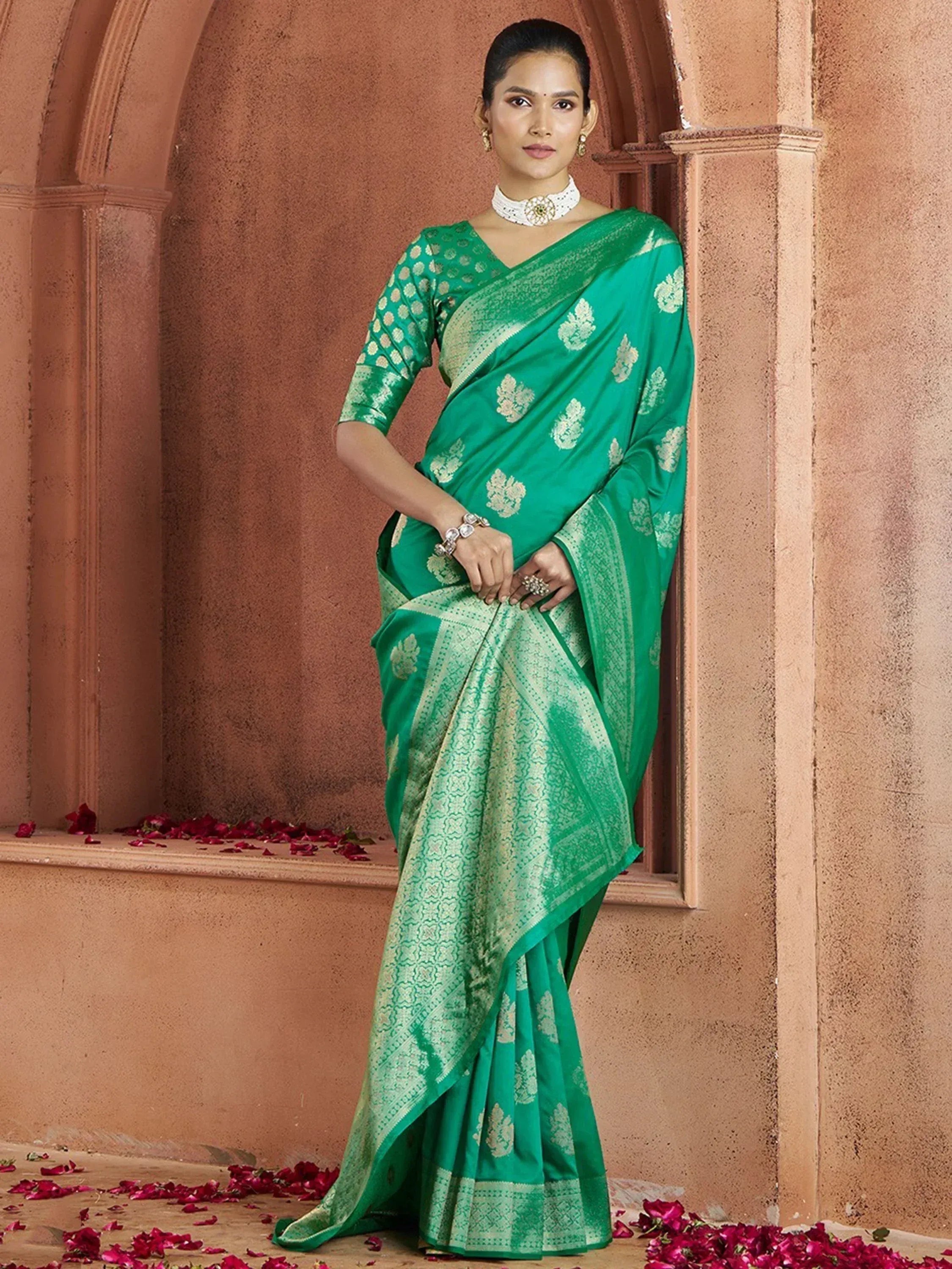 Emerald green designer saree with gold floral motifs, perfect for Indian ethnic occasions