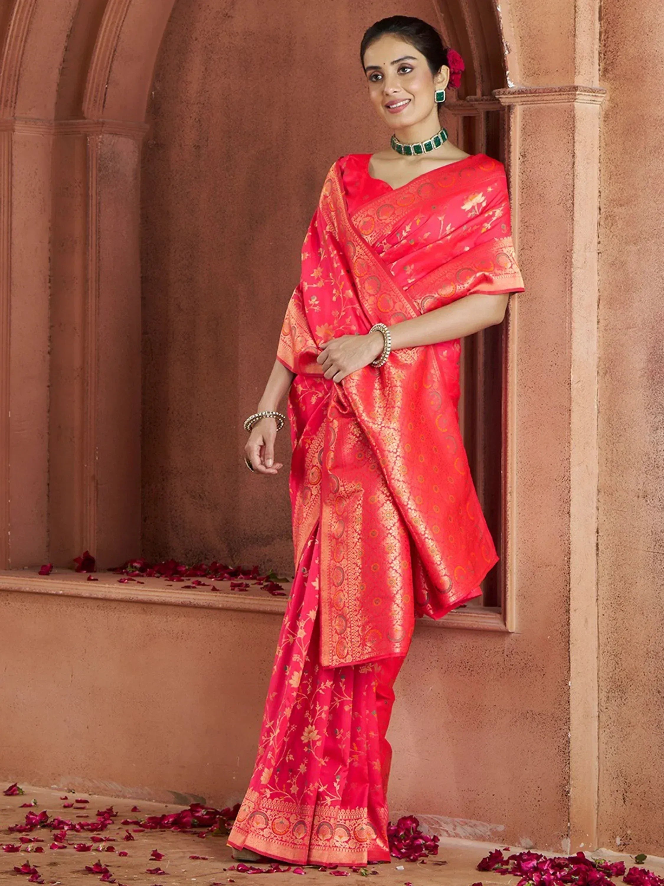 Woman in vibrant red designer saree with gold floral motifs, traditional Indian ethnic wear