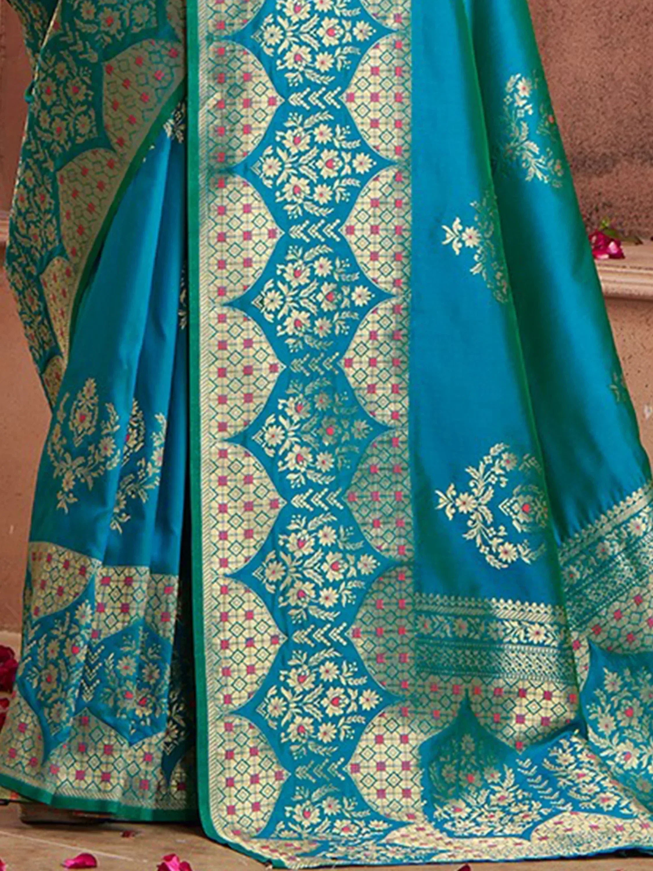 Teal blue designer saree with intricate gold floral and geometric patterns, perfect for ethnic occasions.