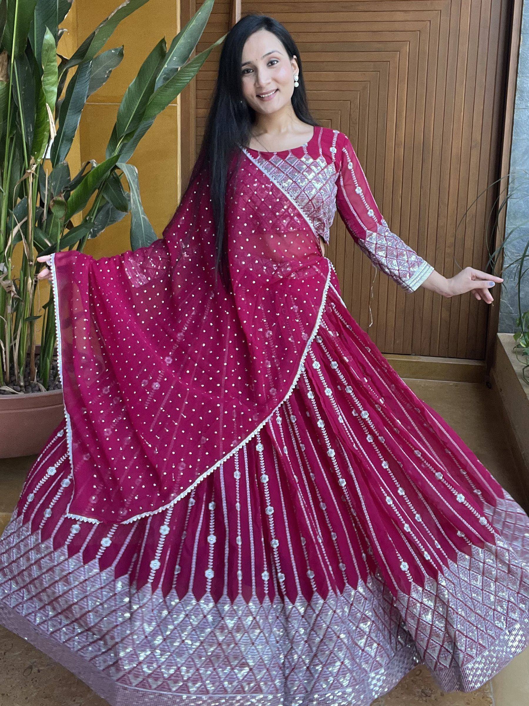 Woman in maroon designer lehenga choli with silver embroidery, perfect for Indian ethnic wear occasions