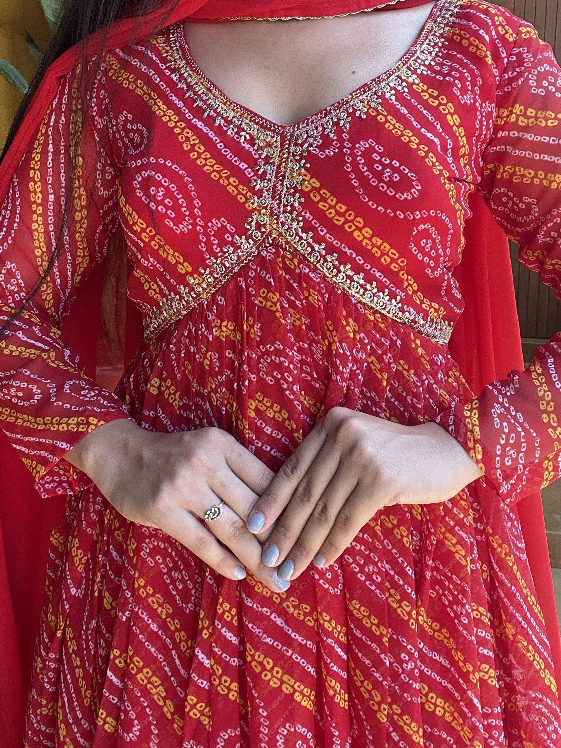 Red printed ethnic anarkali with gold embroidery and sheer sleeves, perfect for Indian festive wear