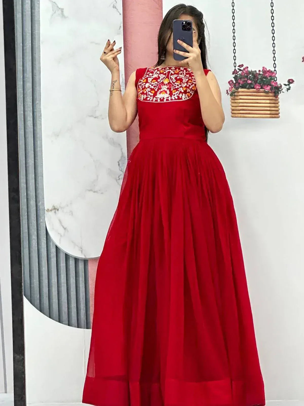 Red ethnic gown with floral embroidery, sleeveless design, pleated skirt, perfect for Indian occasions