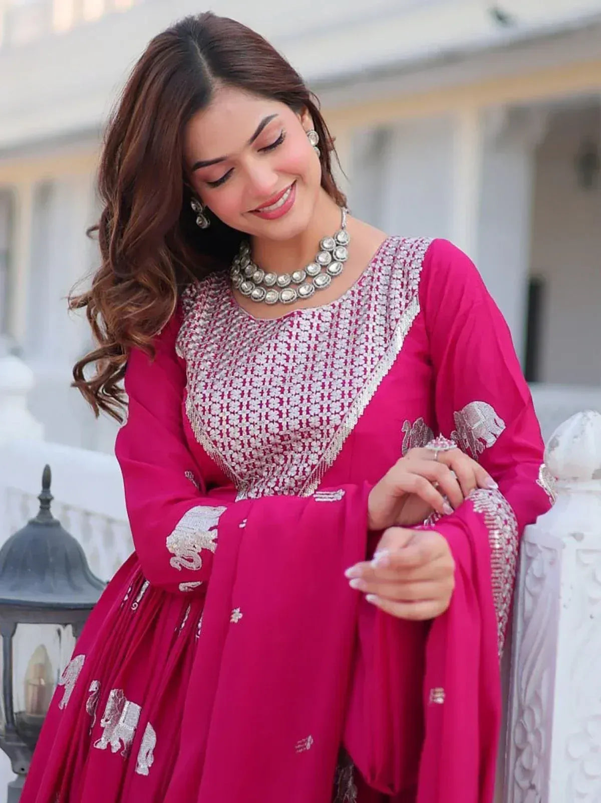 Pink ethnic gown with silver embroidery and elephant motifs, paired with statement jewelry