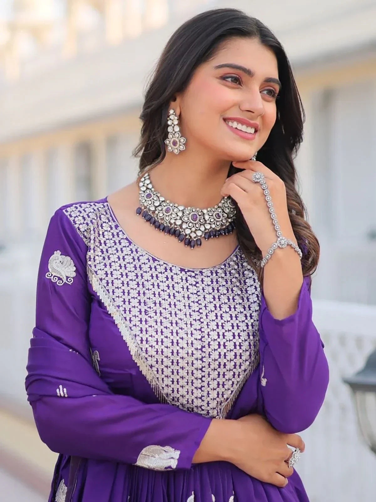 Woman in purple embroidered Anarkali suit with silver jewelry, outdoor setting