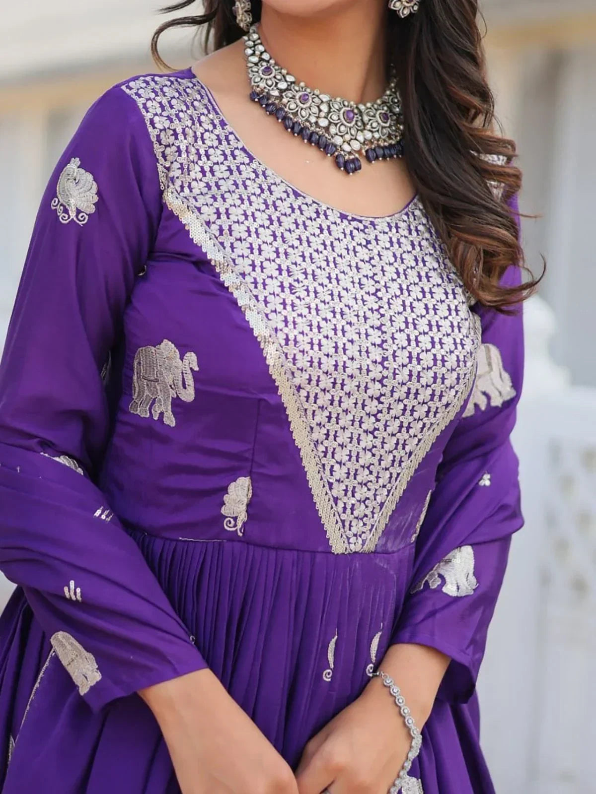 Purple ethnic gown with silver embroidery, elephant motifs, and statement necklace