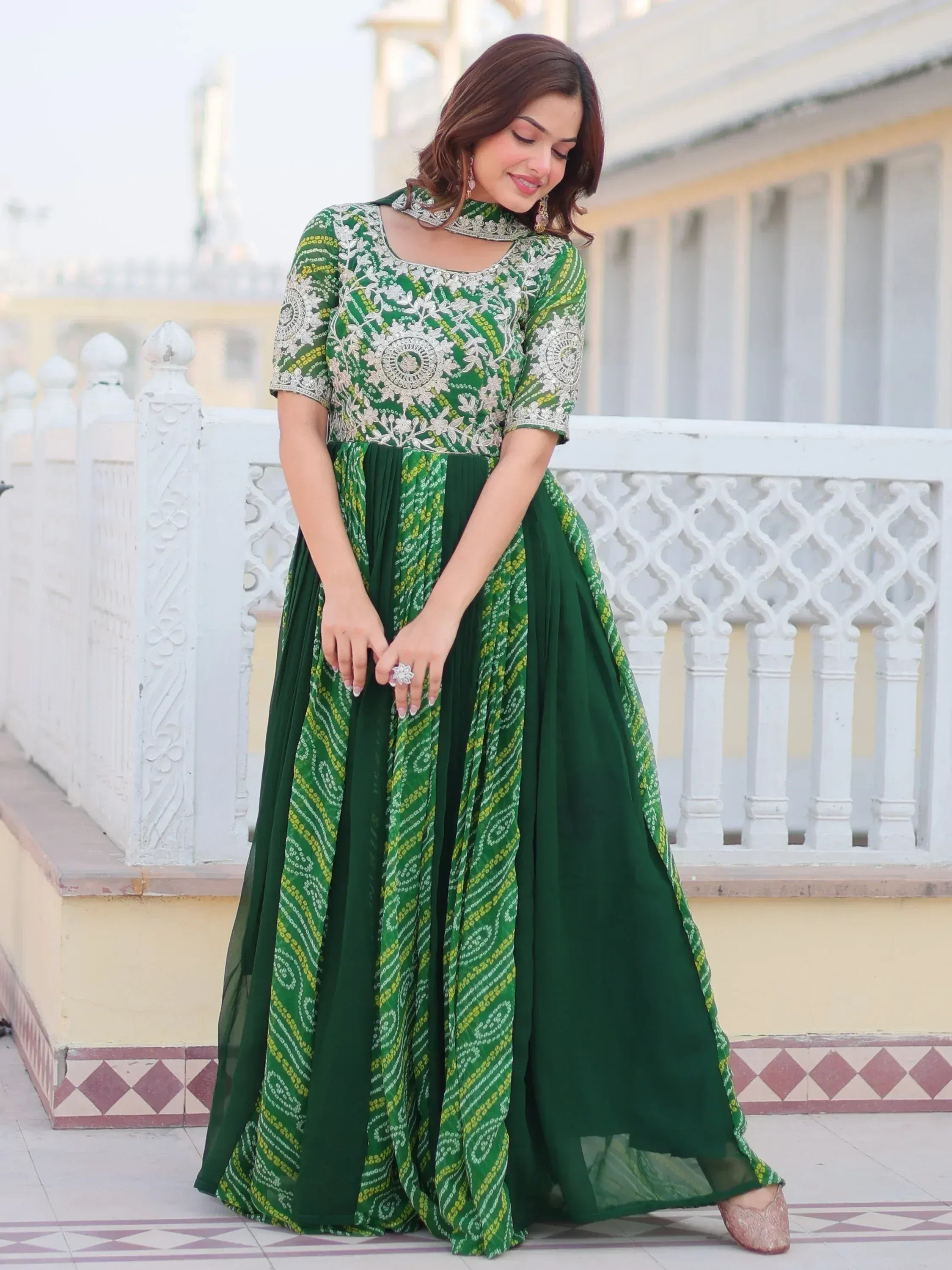 Green embroidered ethnic gown with floral patterns, perfect for Indian festive occasions