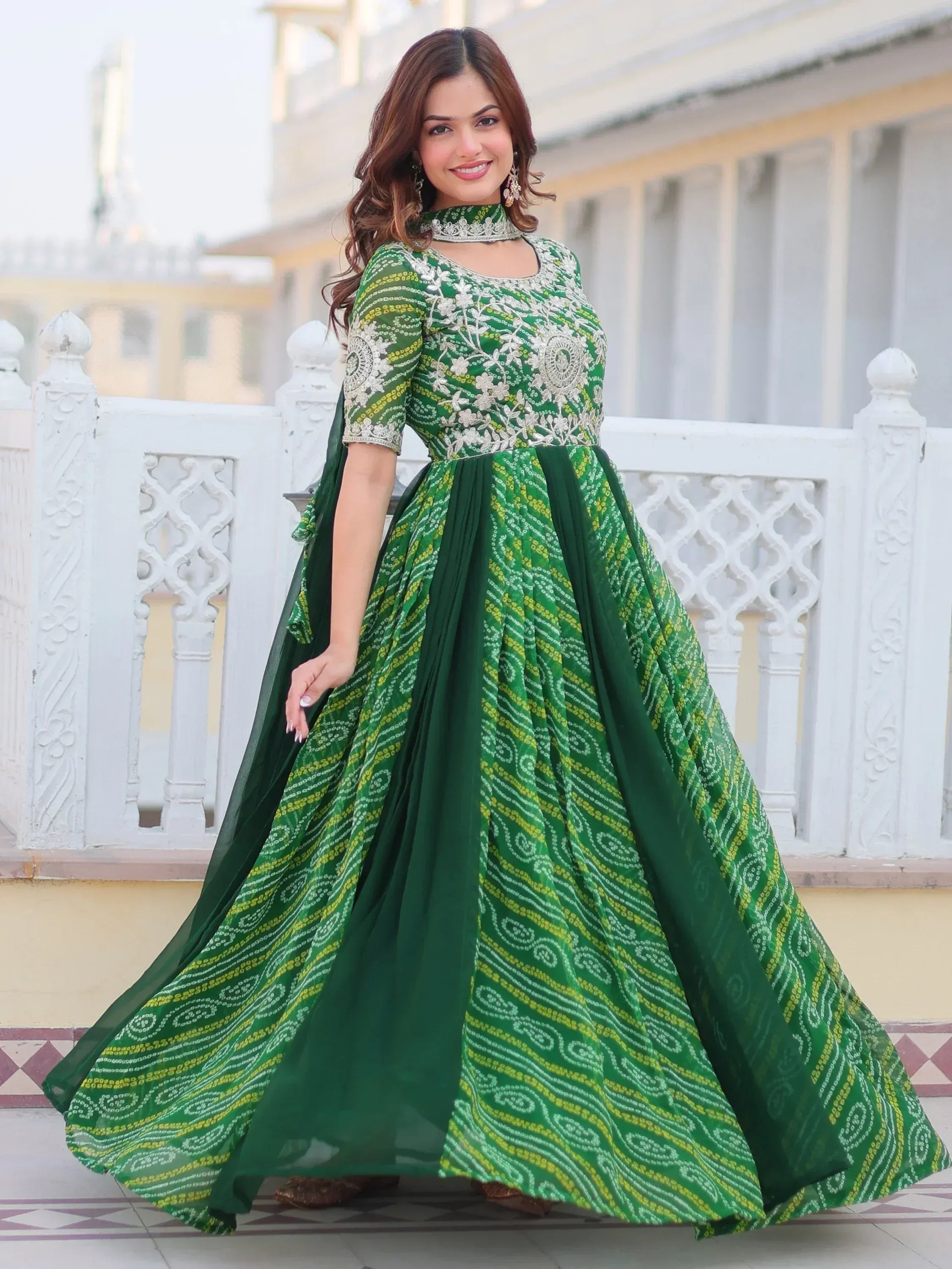 Green embroidered anarkali gown with floral motifs and flared skirt, perfect for Indian ethnic occasions