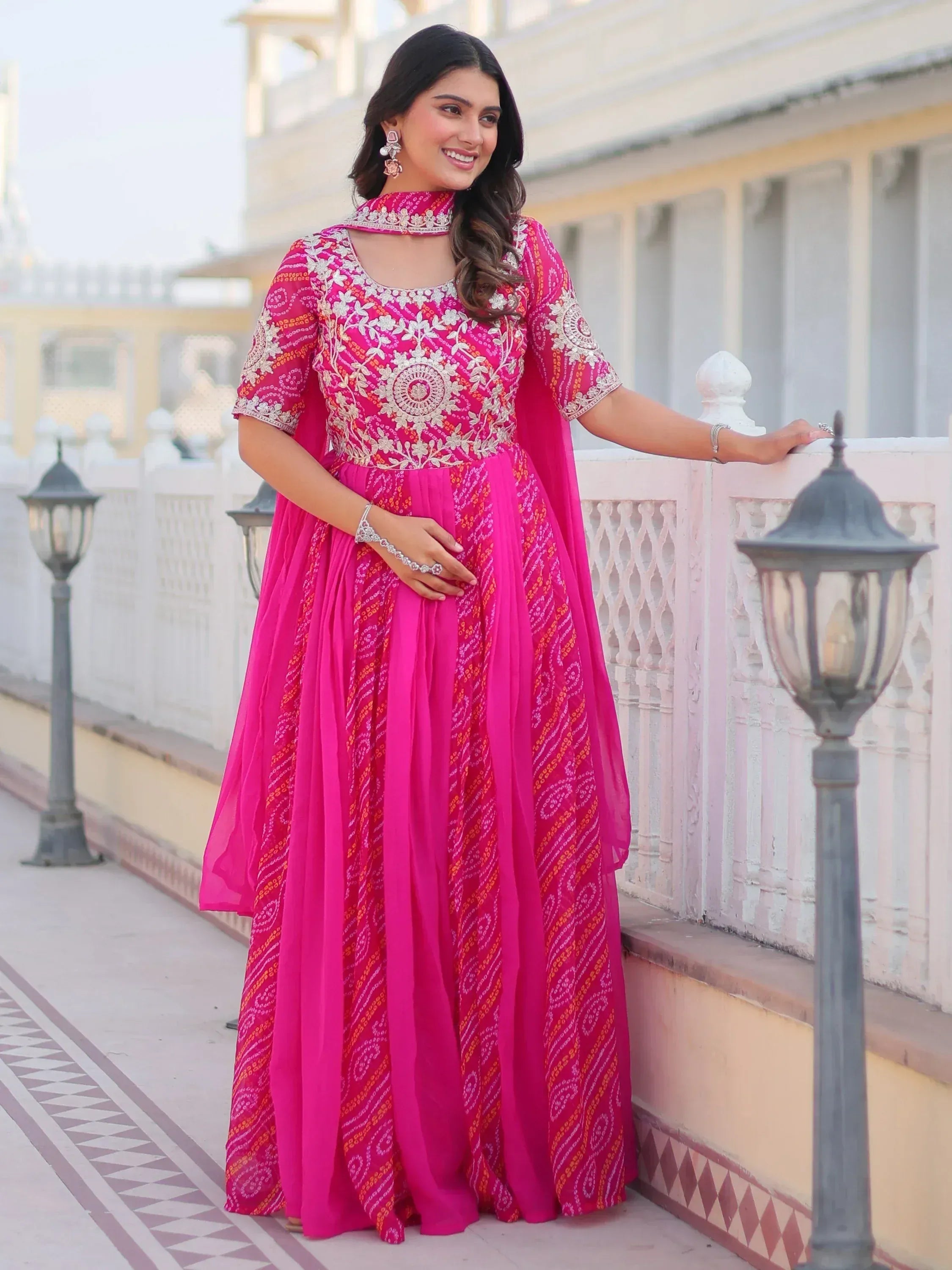 Pink embroidered ethnic gown with floral motifs, perfect for Indian celebrations and festive occasions.