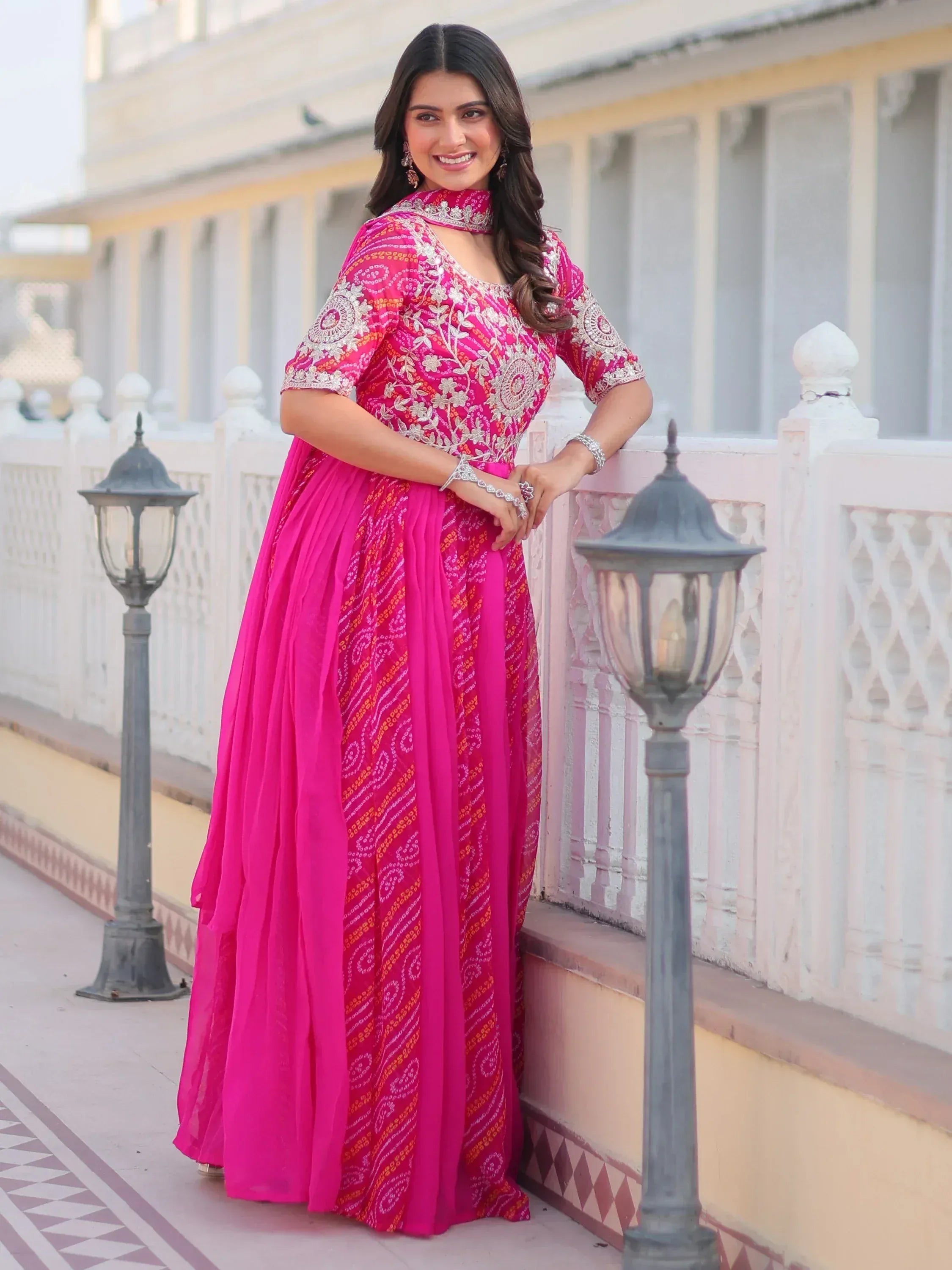 Pink embroidered ethnic gown with floral patterns, perfect for Indian festive occasions and weddings.