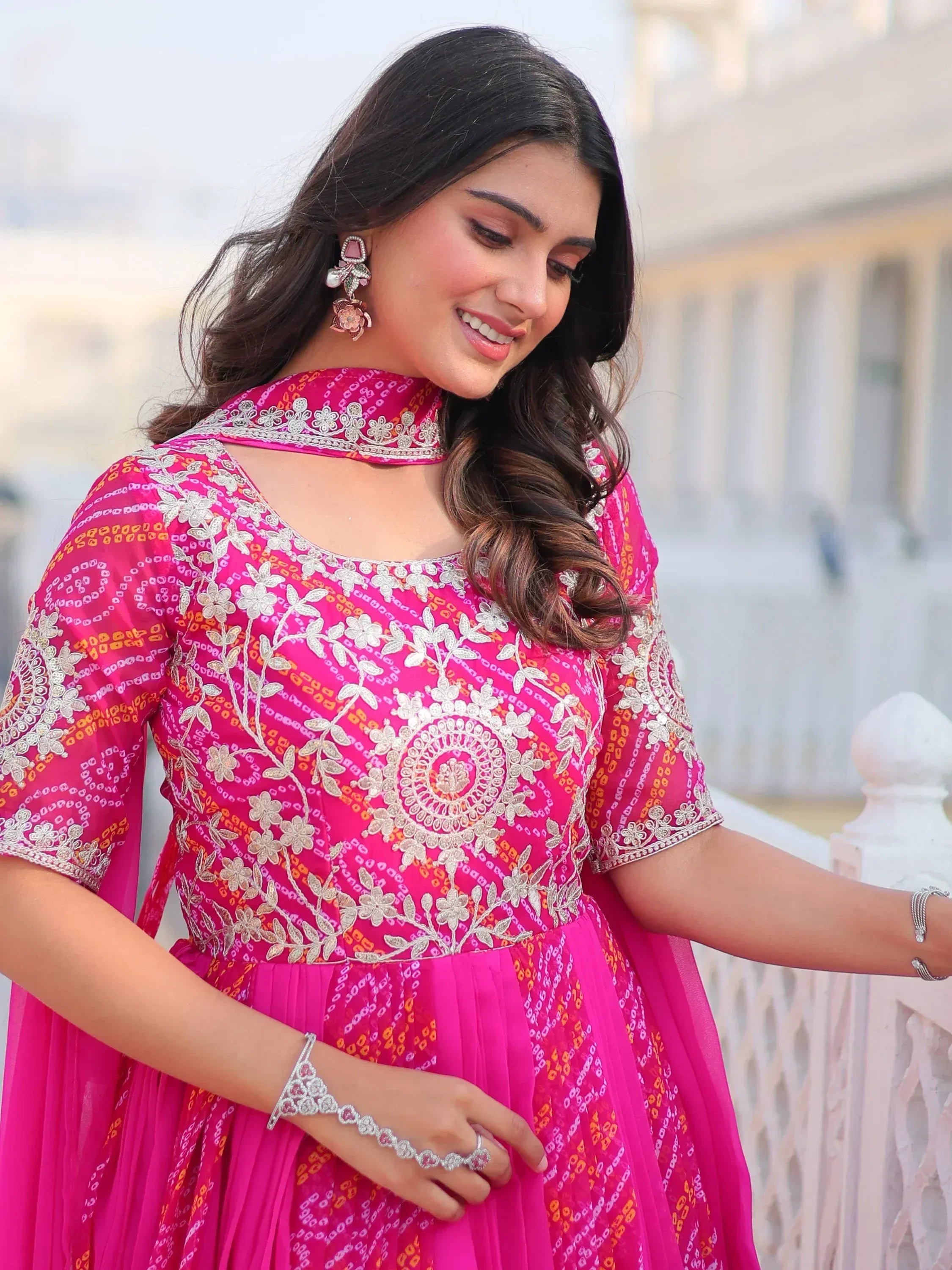 Pink embroidered ethnic gown with floral design, perfect for Indian occasions and festive wear.
