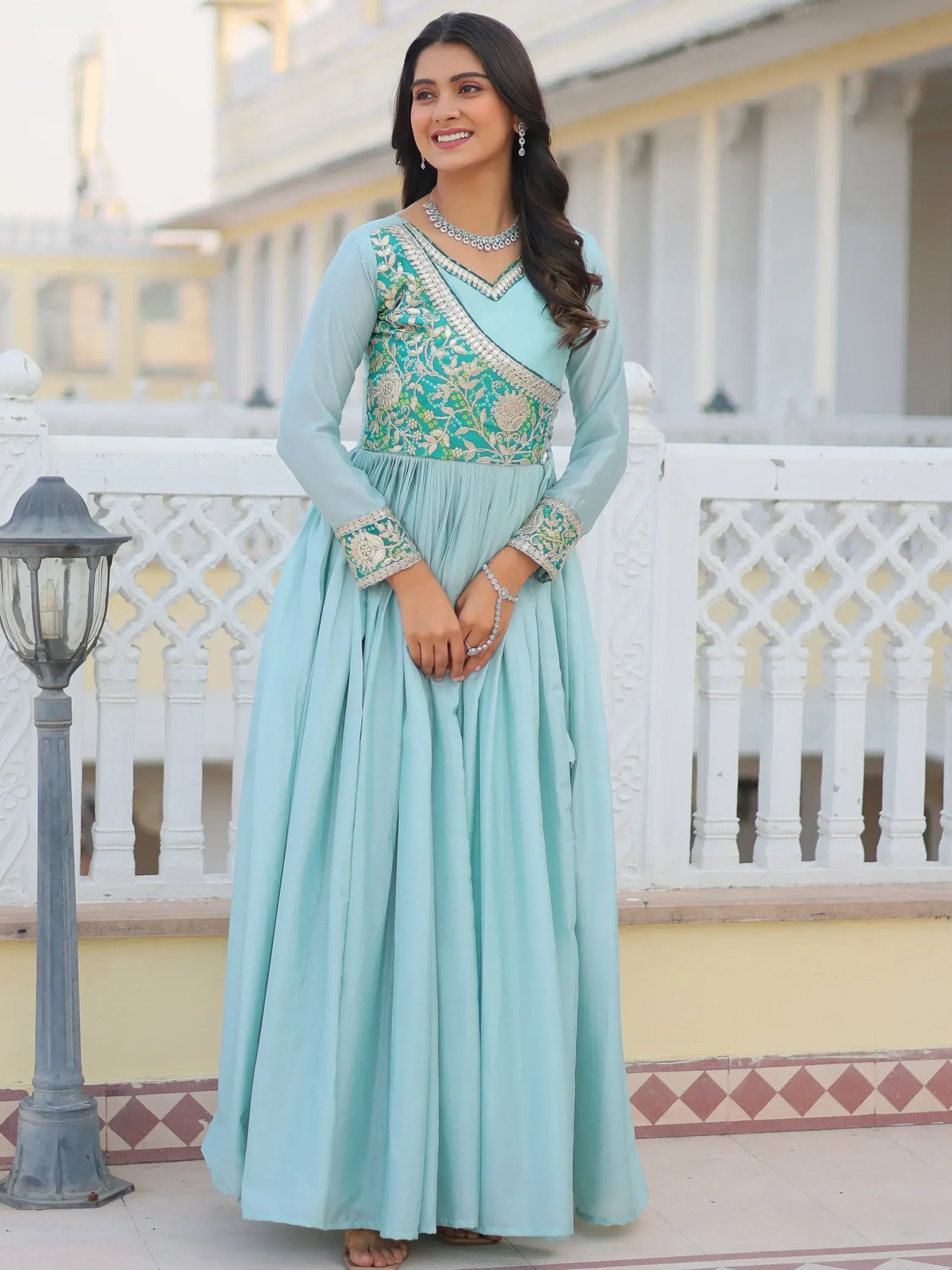 Light blue ethnic gown with green gold embroidery, perfect for Indian occasions and festive wear.