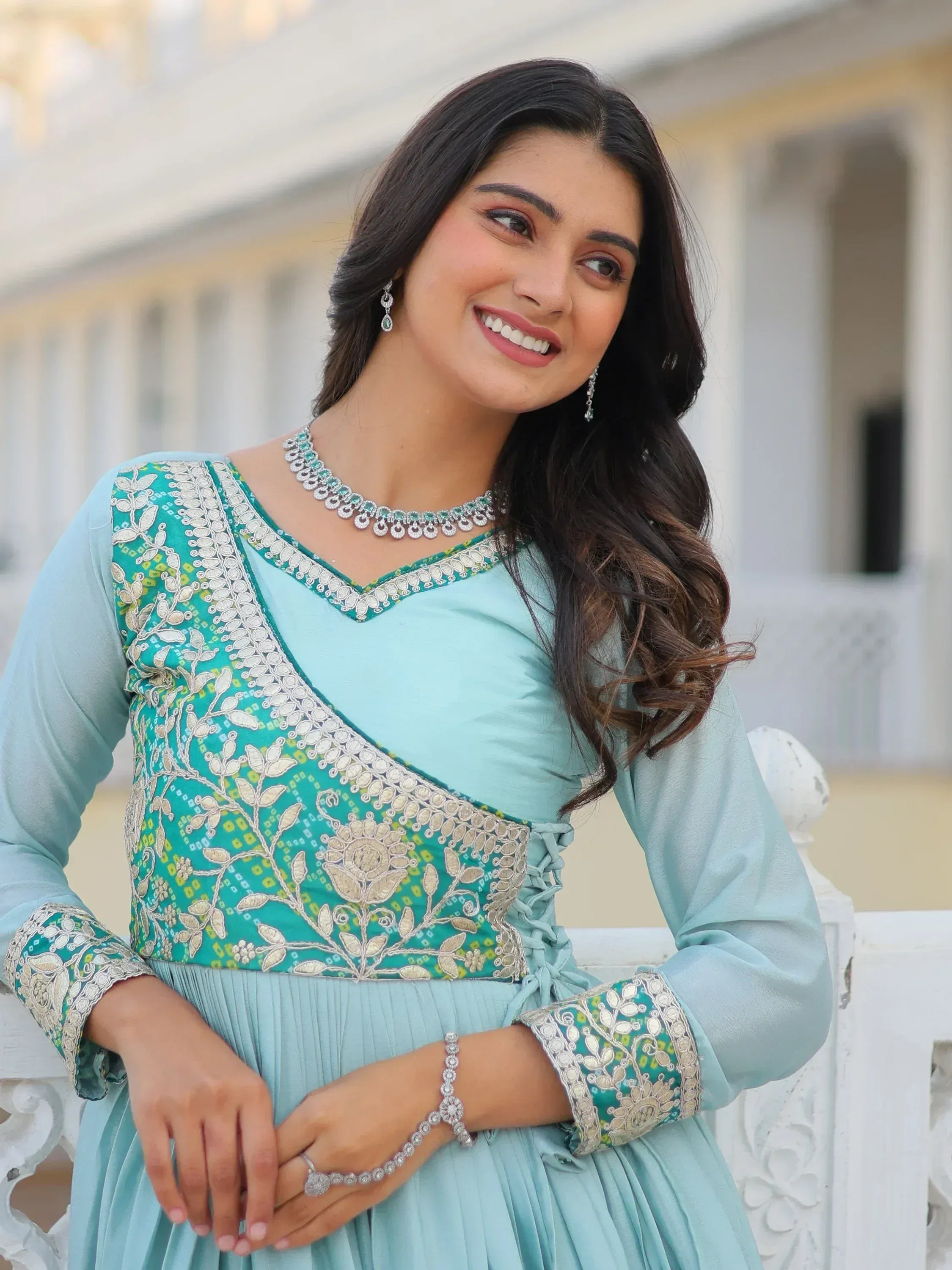 Elegant turquoise ethnic gown with floral embroidery and matching jewelry for festive occasions