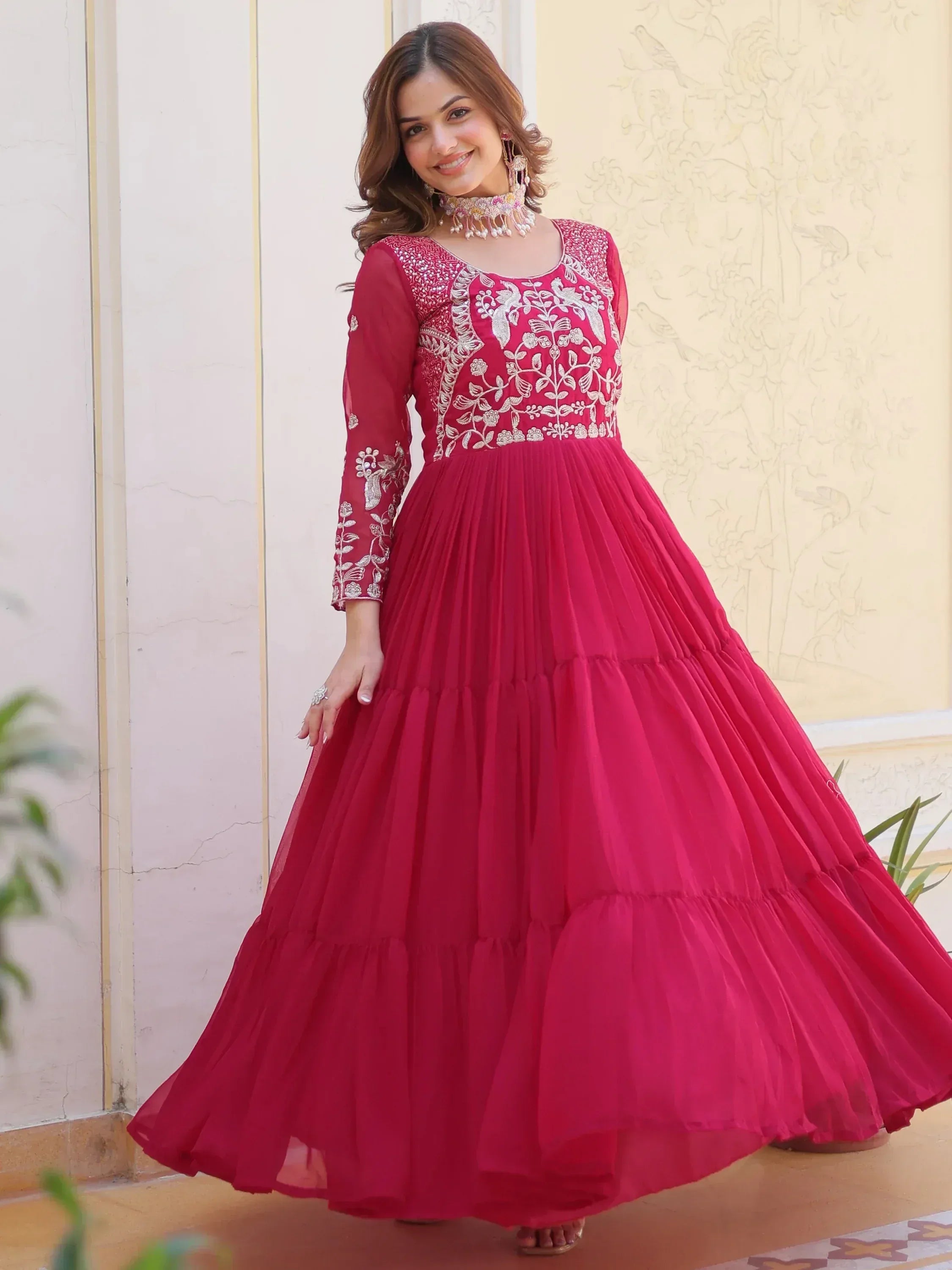 Pink embroidered ethnic gown with layered skirt, perfect for Indian occasions and festive wear.