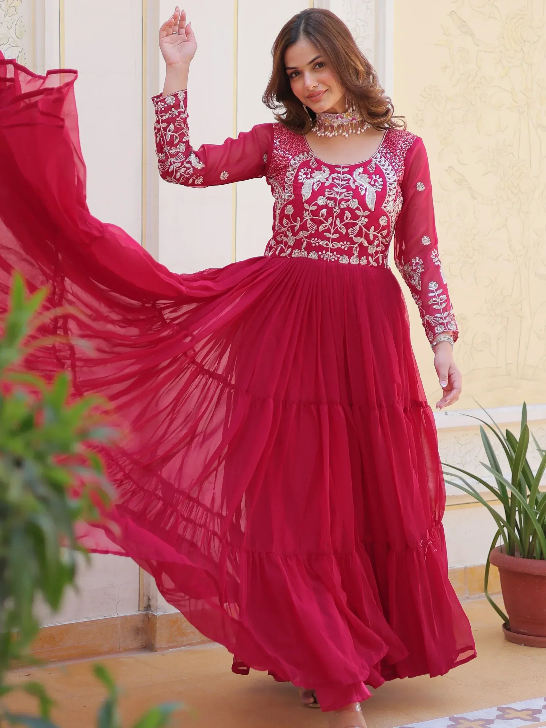 Red embroidered ethnic gown with flowing skirt, perfect for Indian celebrations and festive occasions.