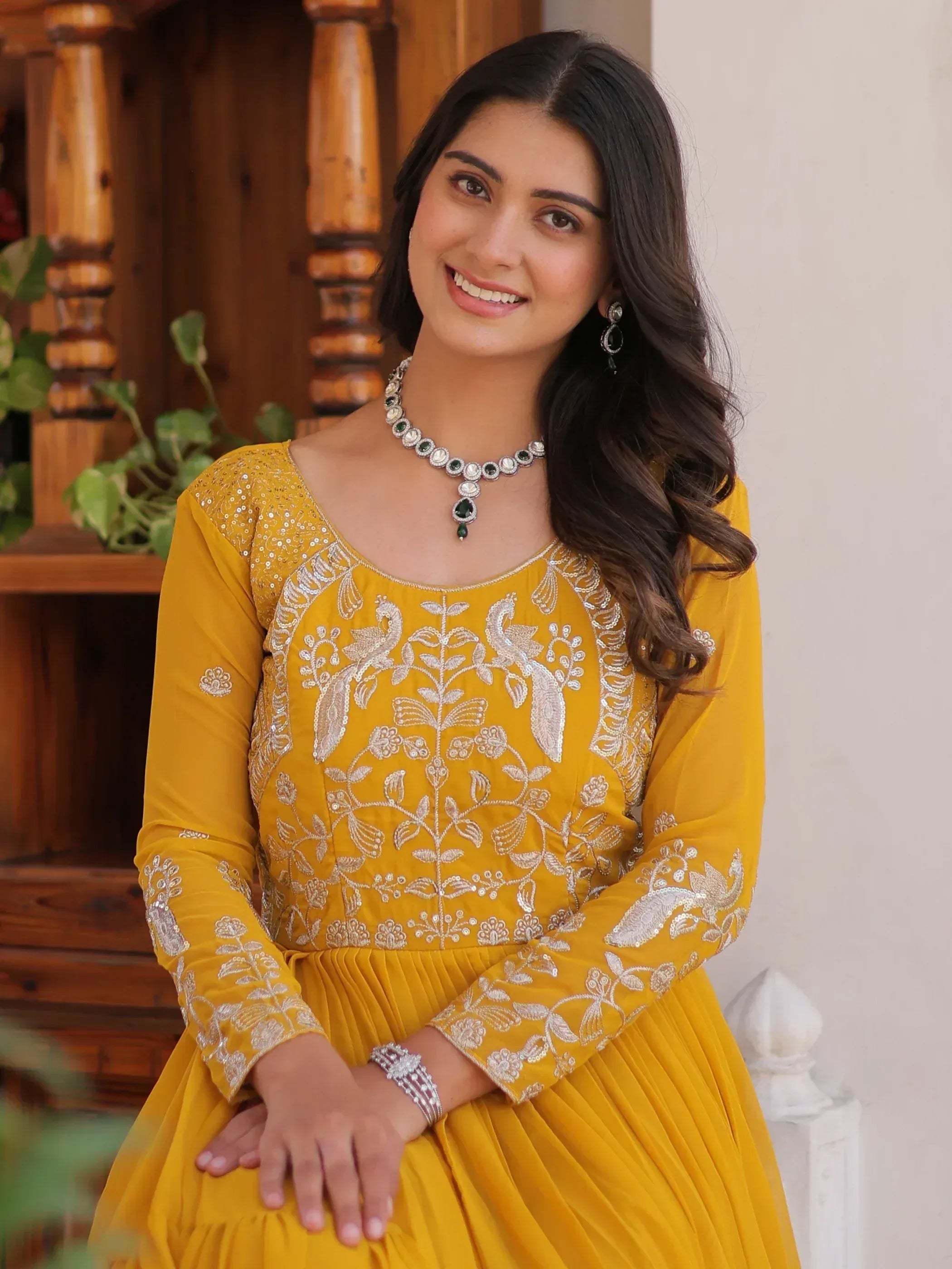 Yellow embroidered ethnic gown with peacock design, perfect for Indian occasions and festive wear.