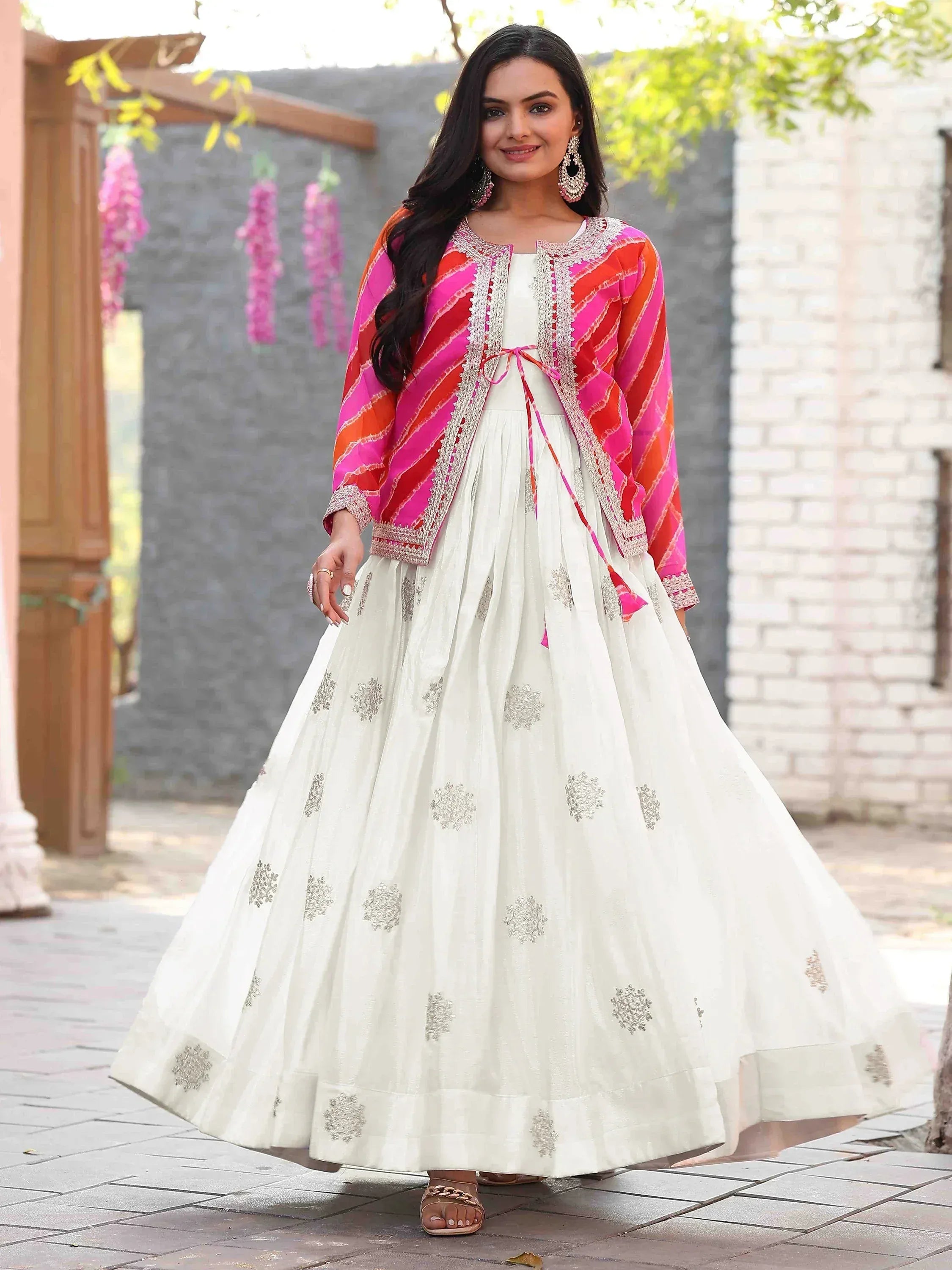 White embroidered lehenga with pink-orange striped jacket, perfect for ethnic occasions