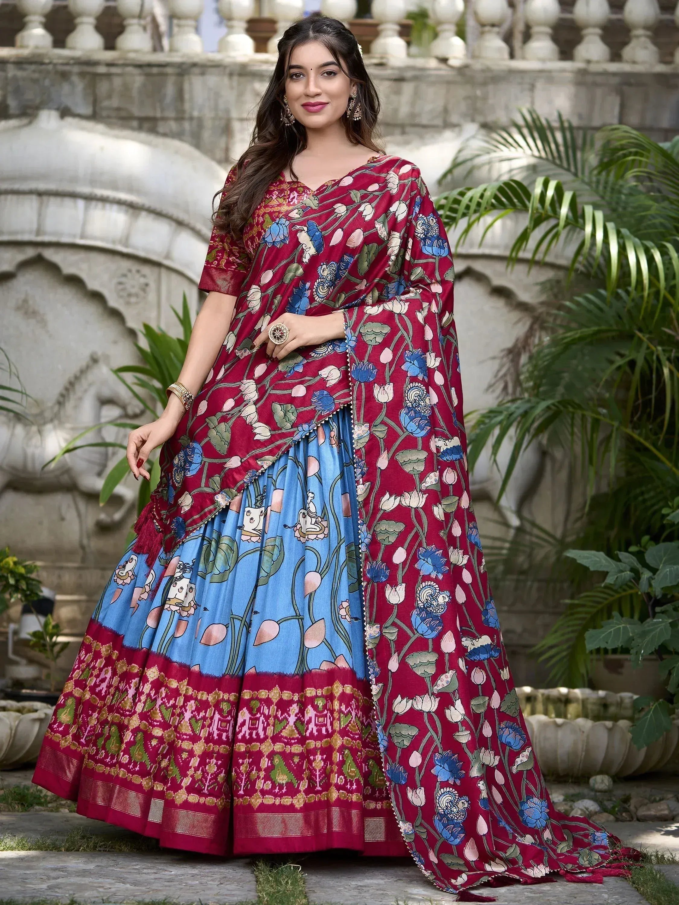 Woman in maroon and blue floral print lehenga choli with traditional Indian ethnic wear design