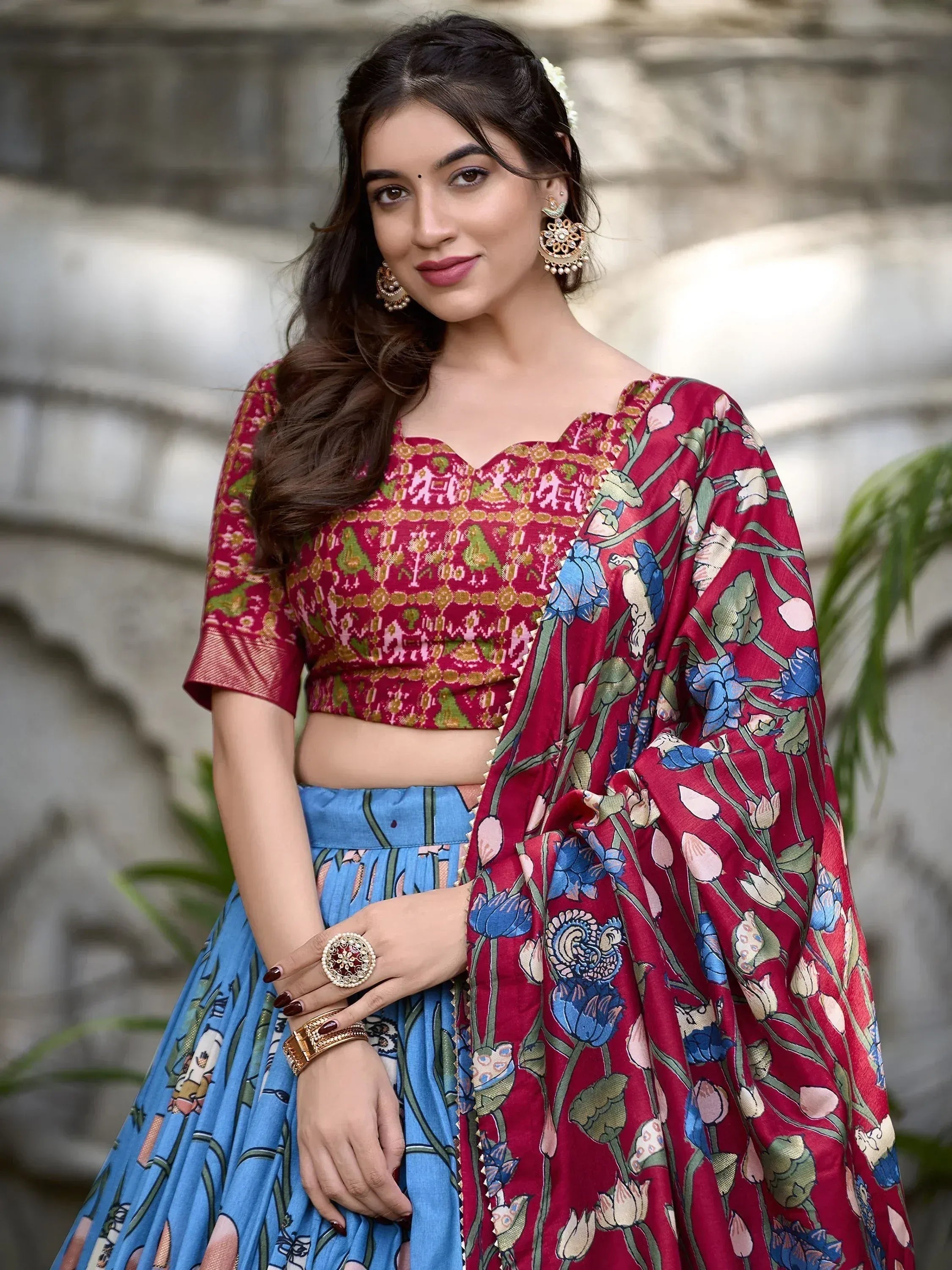Woman in red and blue floral lehenga choli with designer blouse and dupatta, ethnic Indian wear