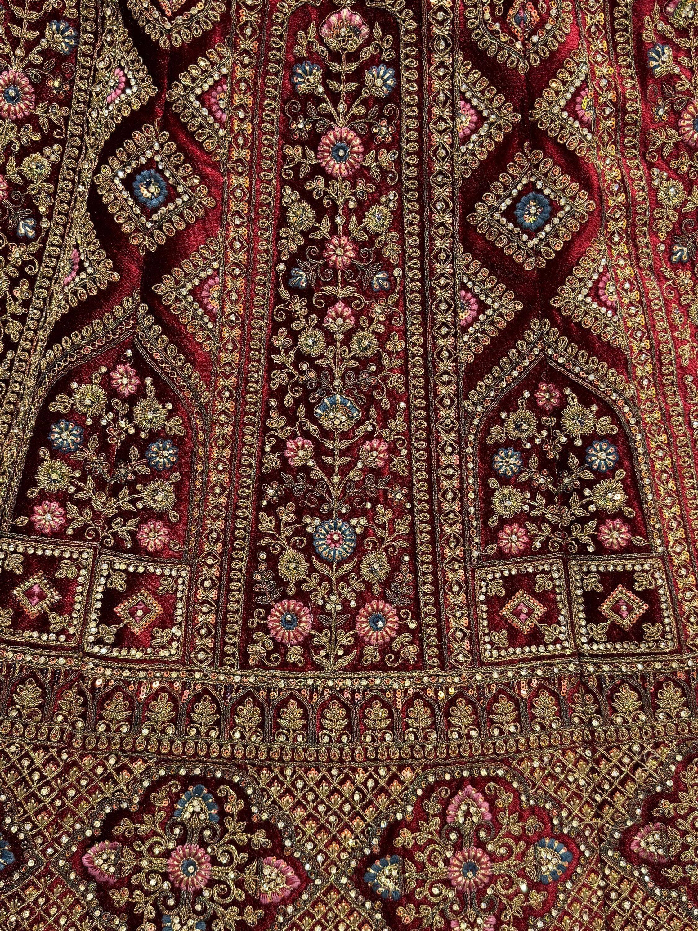 Rich maroon velvet with intricate gold floral embroidery and sequin detailing for ethnic wear