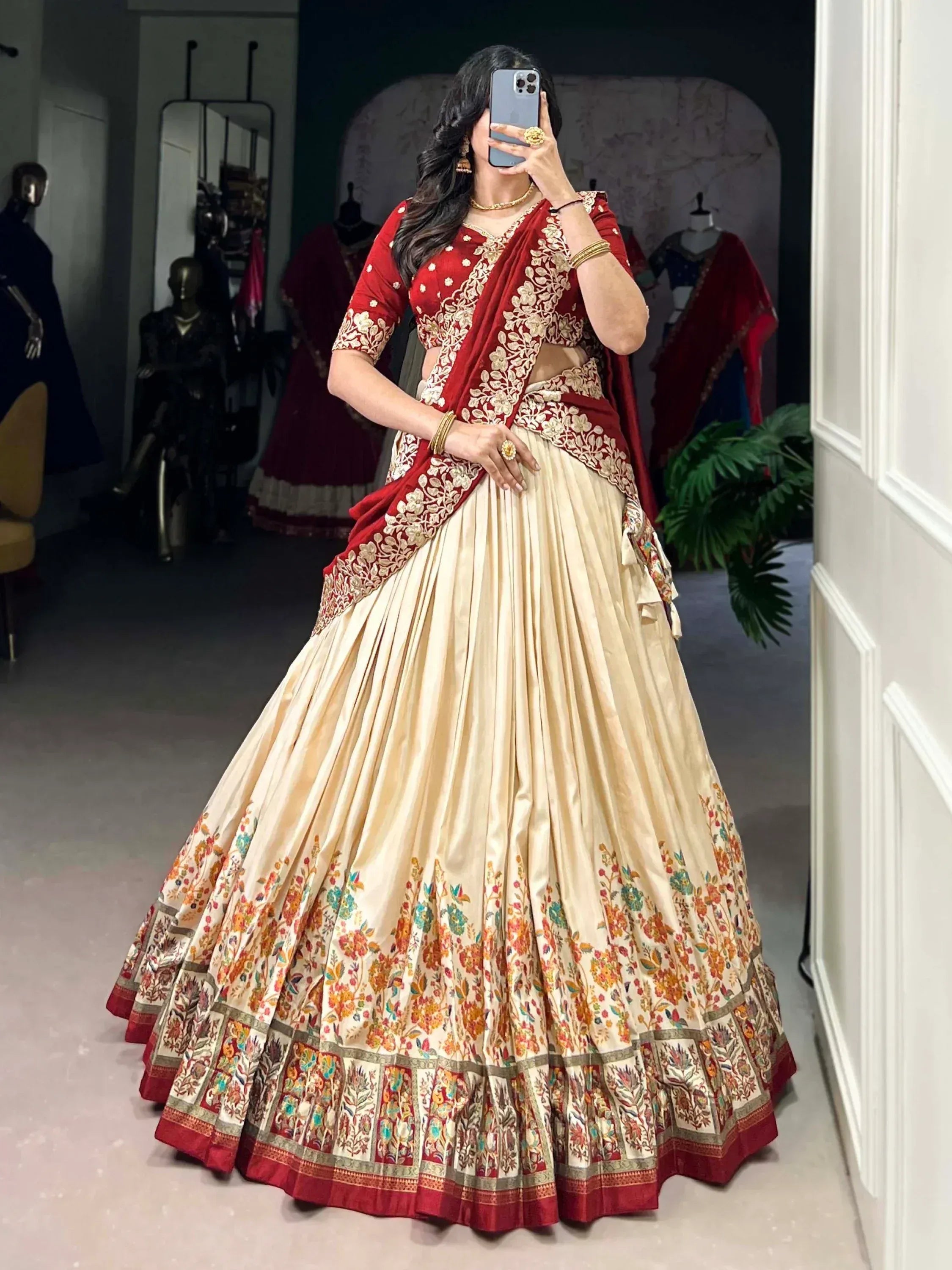Red and cream embroidered lehenga choli with floral border, perfect for Indian weddings and festive occasions.