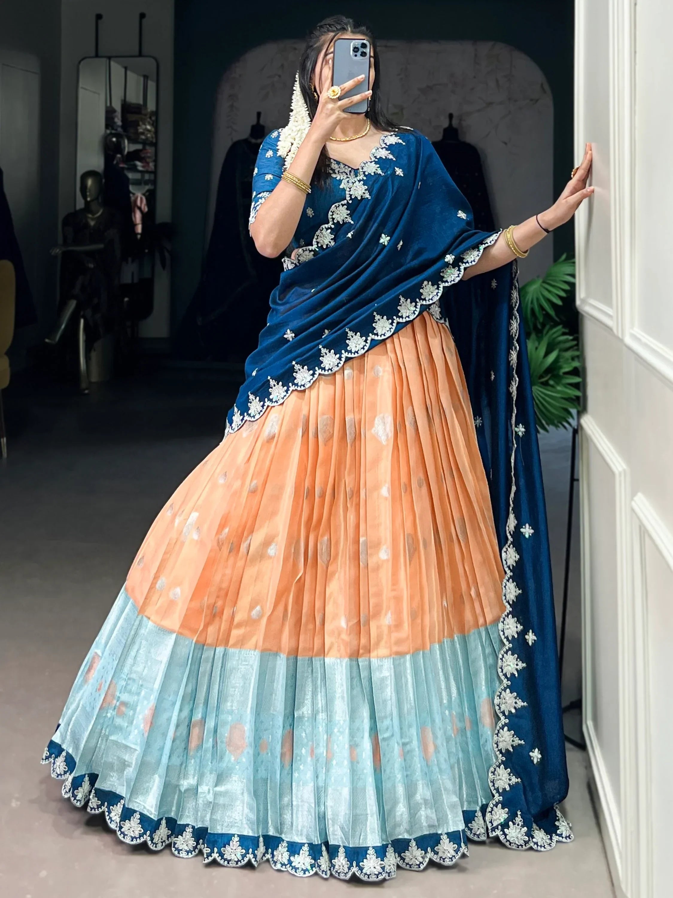 Blue velvet embroidered lehenga choli with peach and mint pleated skirt, perfect for Indian ethnic wear