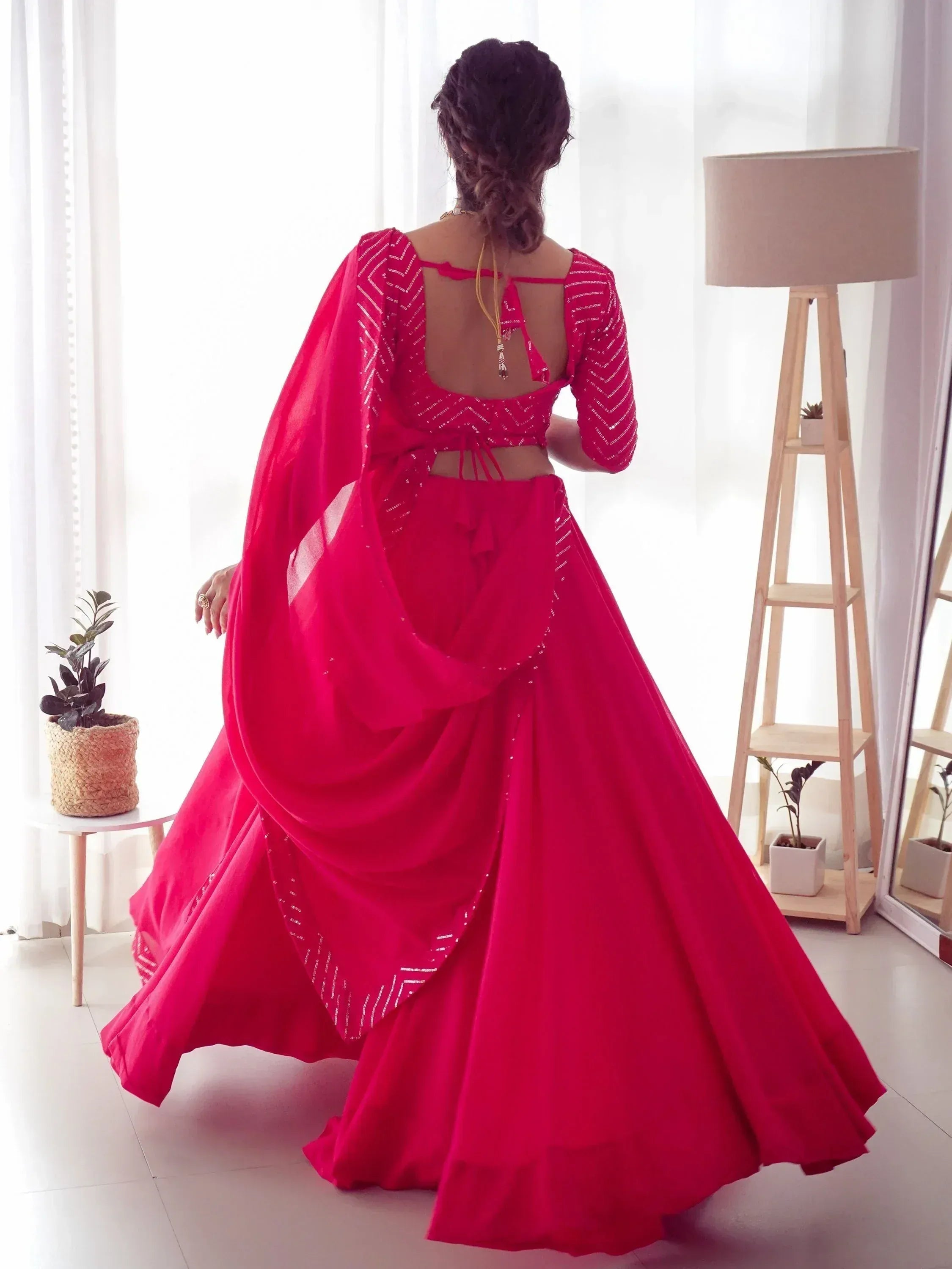 Vibrant red designer lehenga choli with sequin detailing, back view, perfect for Indian ethnic occasions.