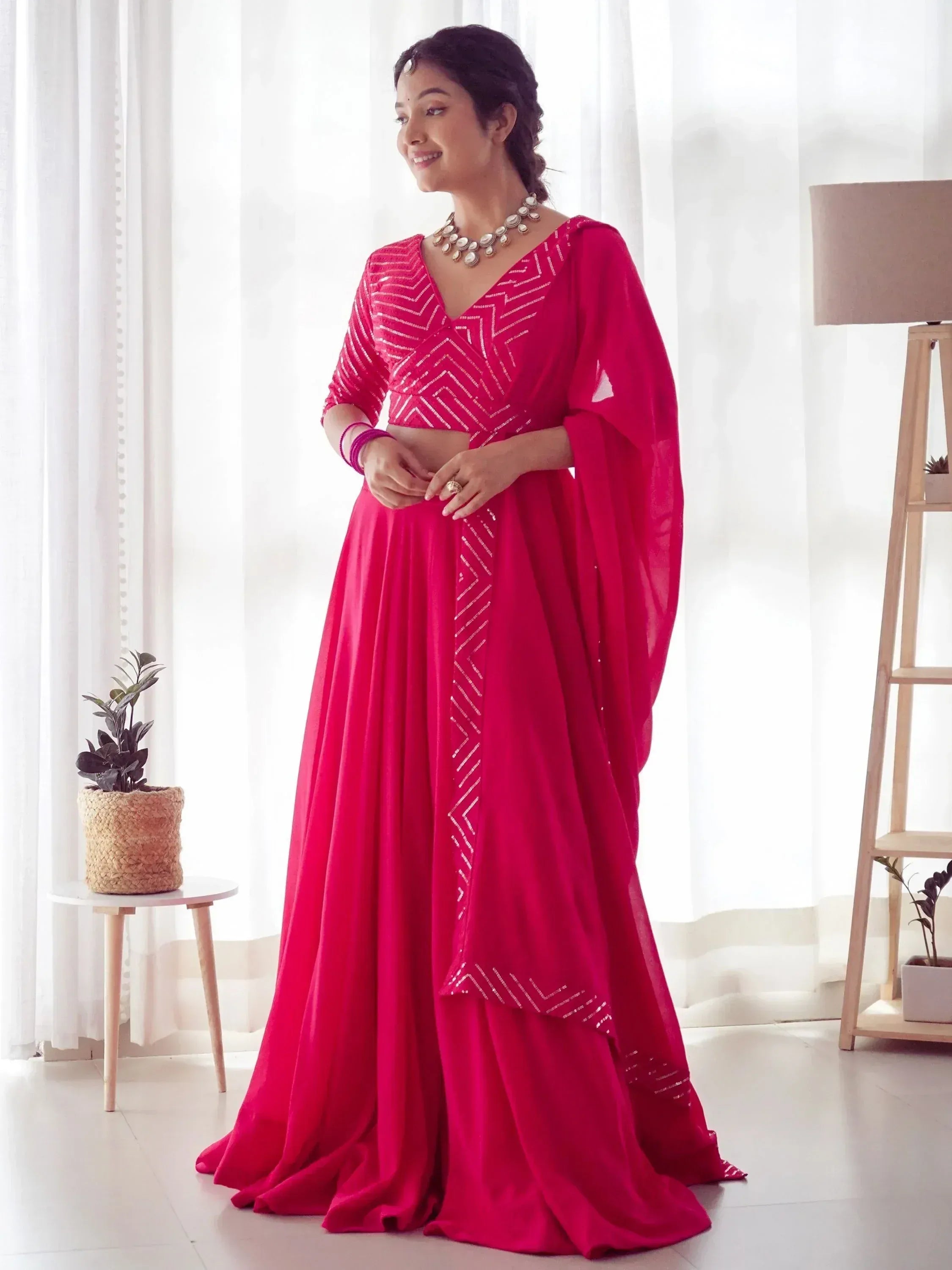 Vibrant pink ethnic gown with geometric sequin detailing, perfect for Indian festive occasions and weddings.