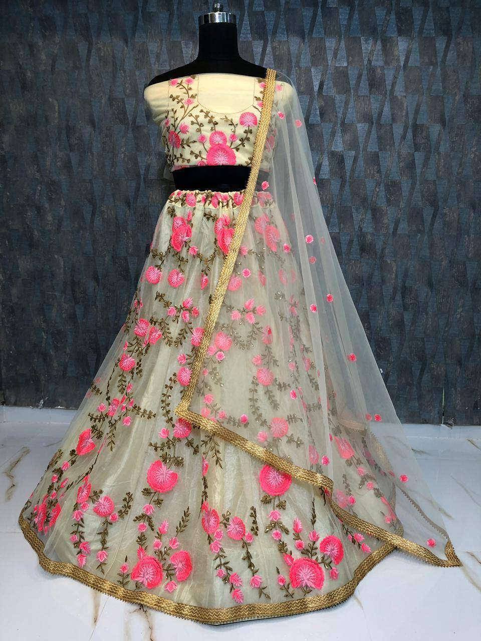 Beige lehenga choli with pink floral embroidery and gold trim, perfect for Indian ethnic wear occasions