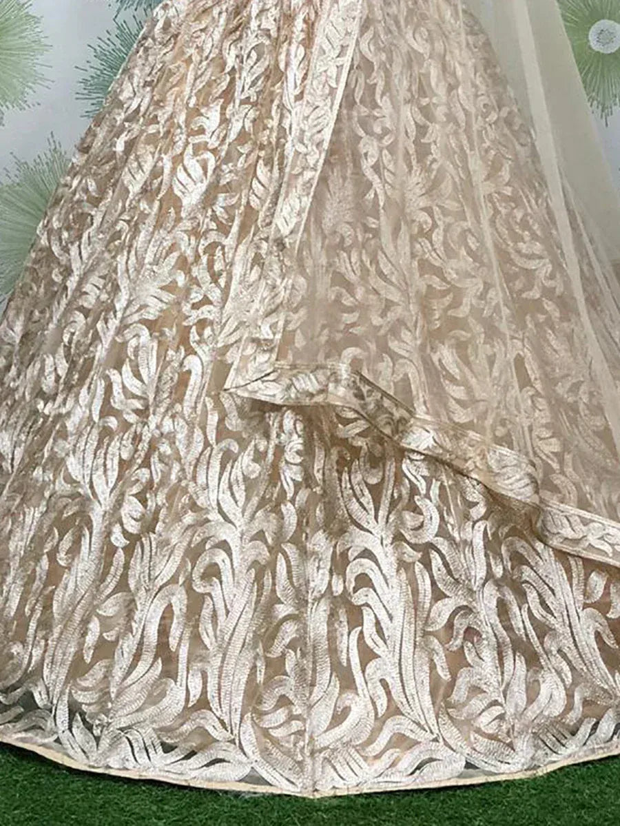 Elegant beige lehenga with intricate silver floral embroidery, perfect for Indian ethnic wear occasions.