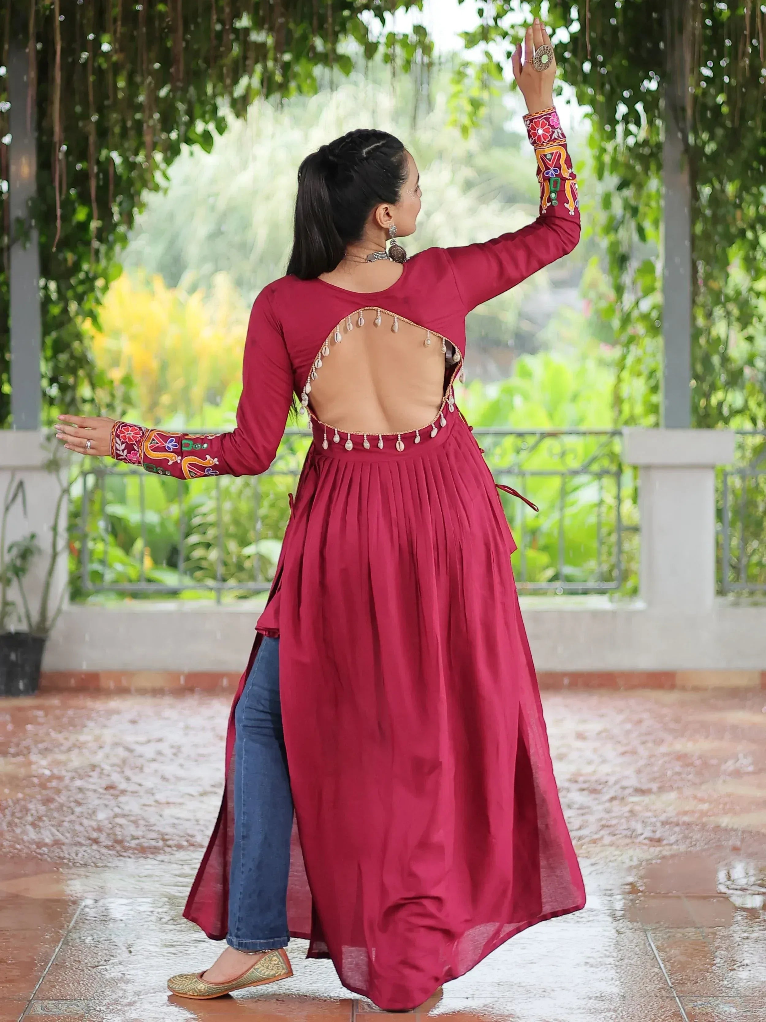 Maroon ethnic gown with back cutout and embroidery, paired with jeans for a fusion look