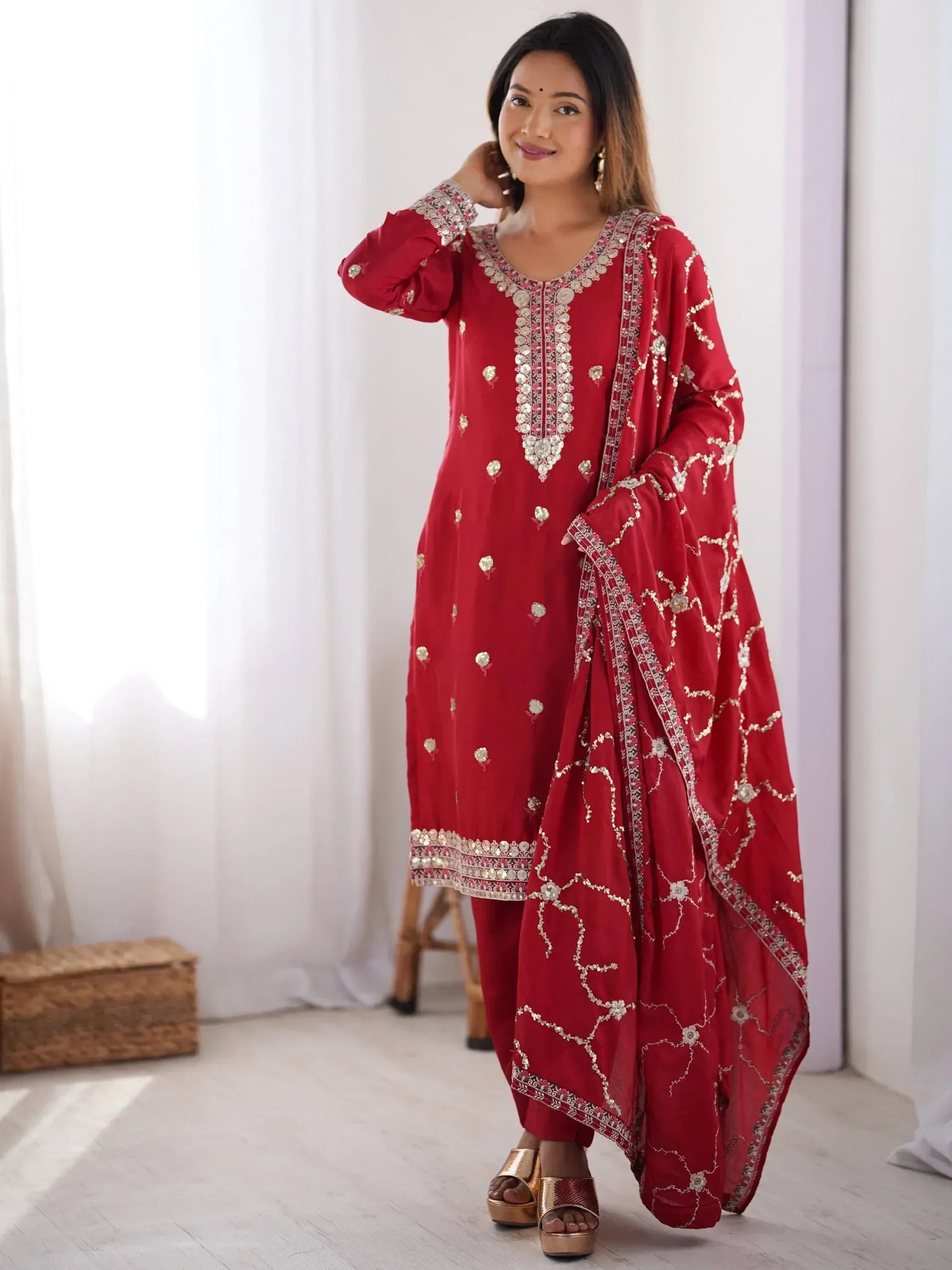 Red embroidered salwar kameez with gold detailing, perfect for ethnic occasions