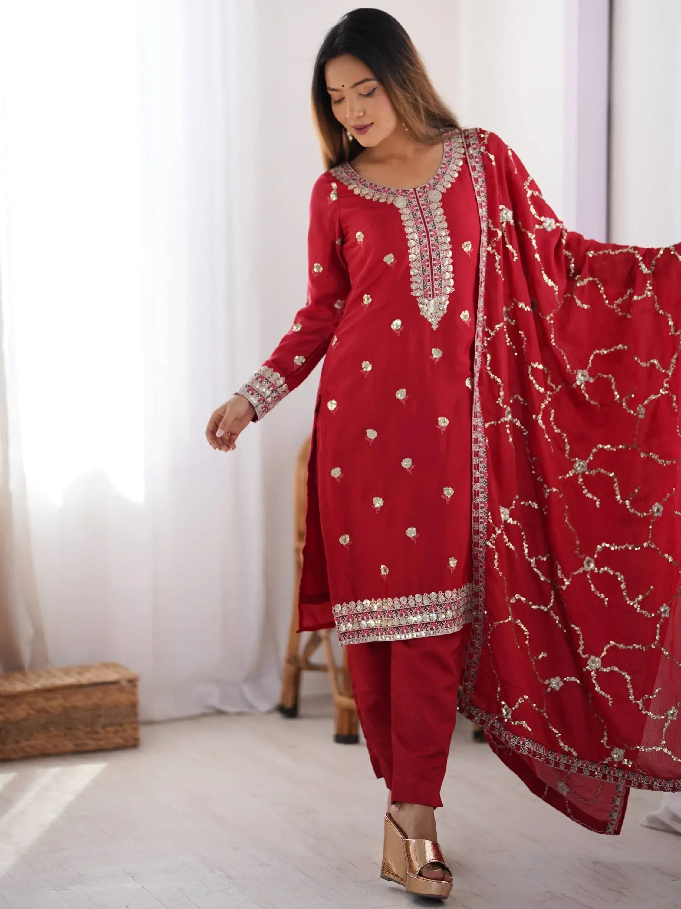 Red embroidered salwar kameez with gold detailing and matching dupatta for ethnic wear