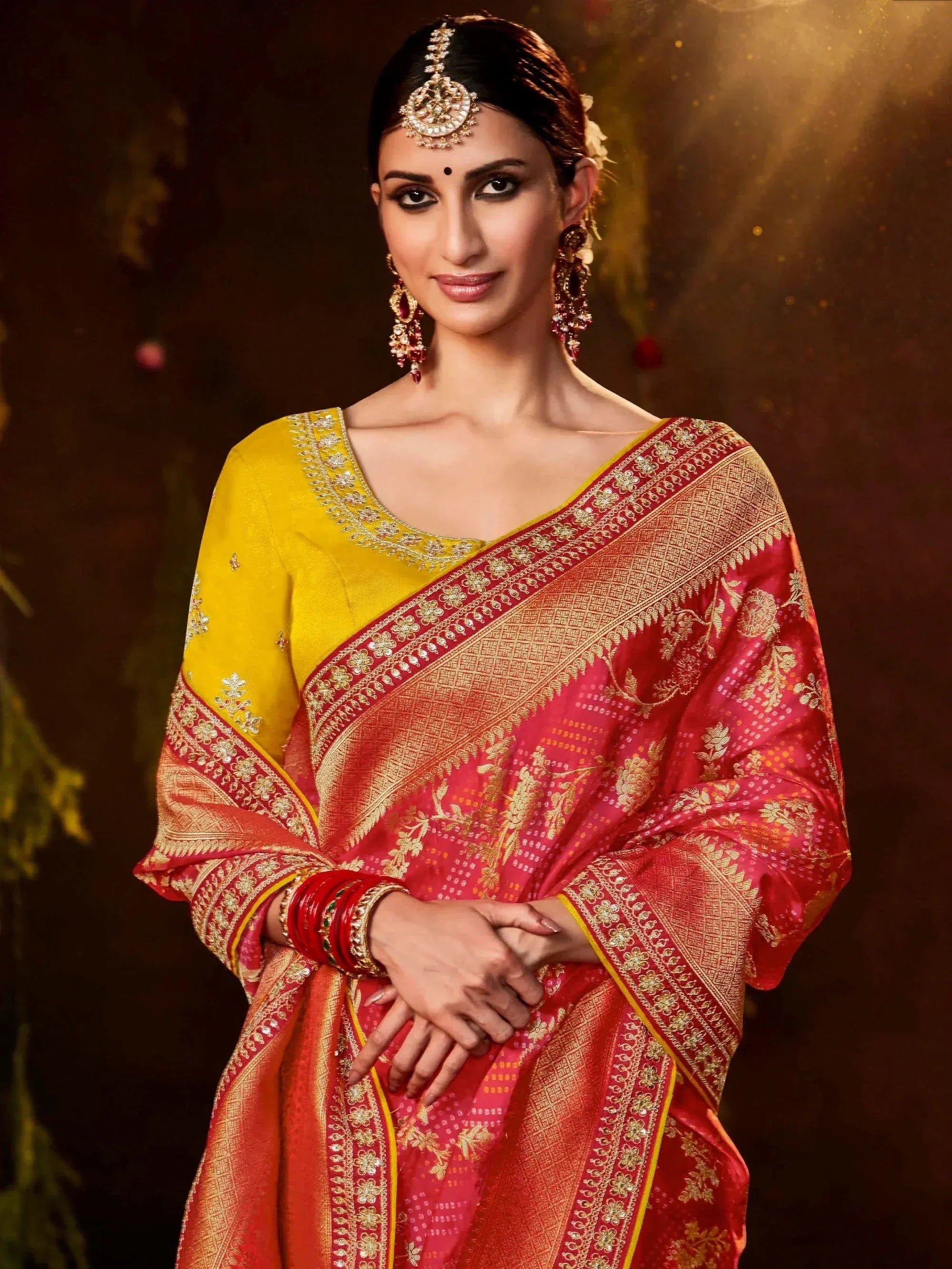 Woman in red and gold embroidered saree with yellow blouse, traditional Indian ethnic wear